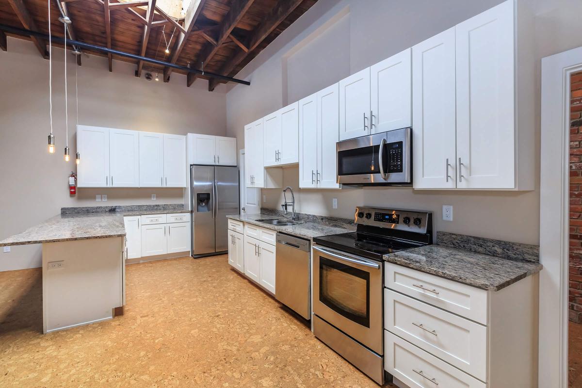 a large kitchen with stainless steel appliances