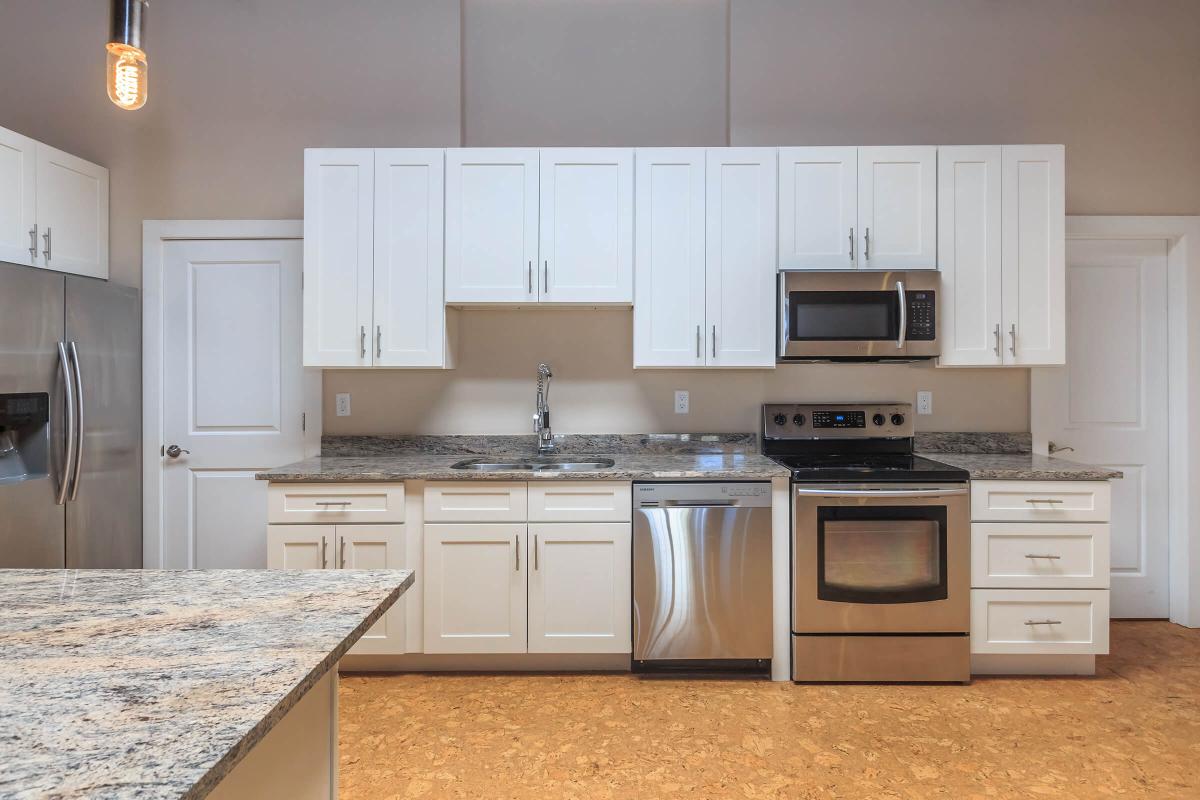 a kitchen with stainless steel appliances and wooden cabinets