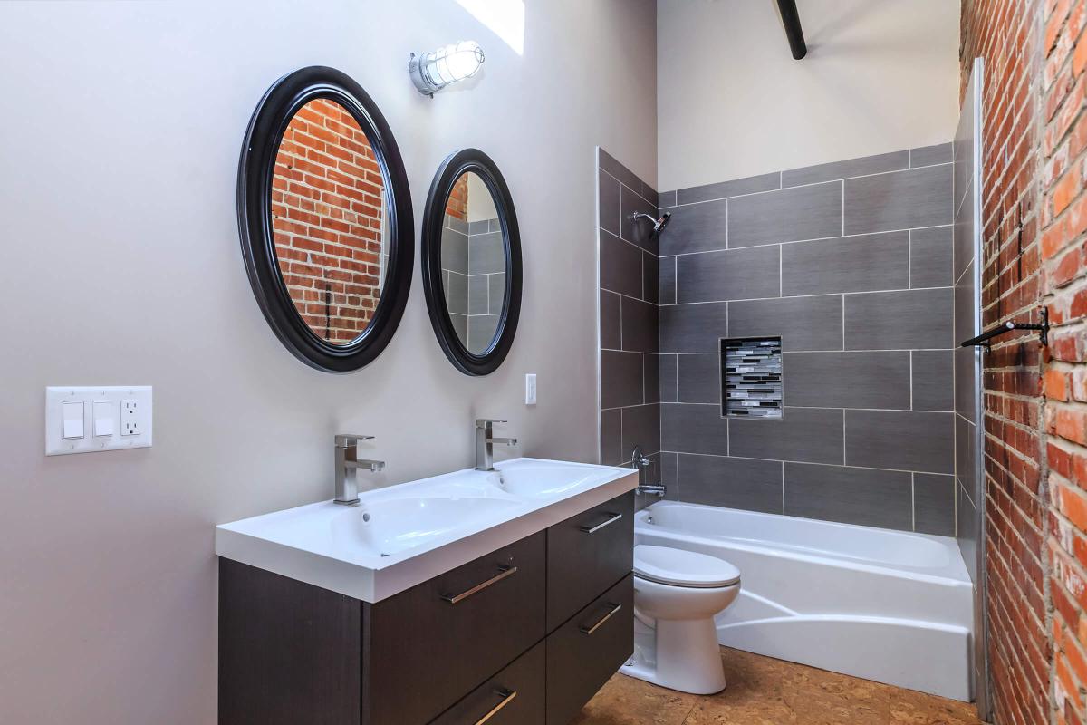 a large white tub sitting next to a sink