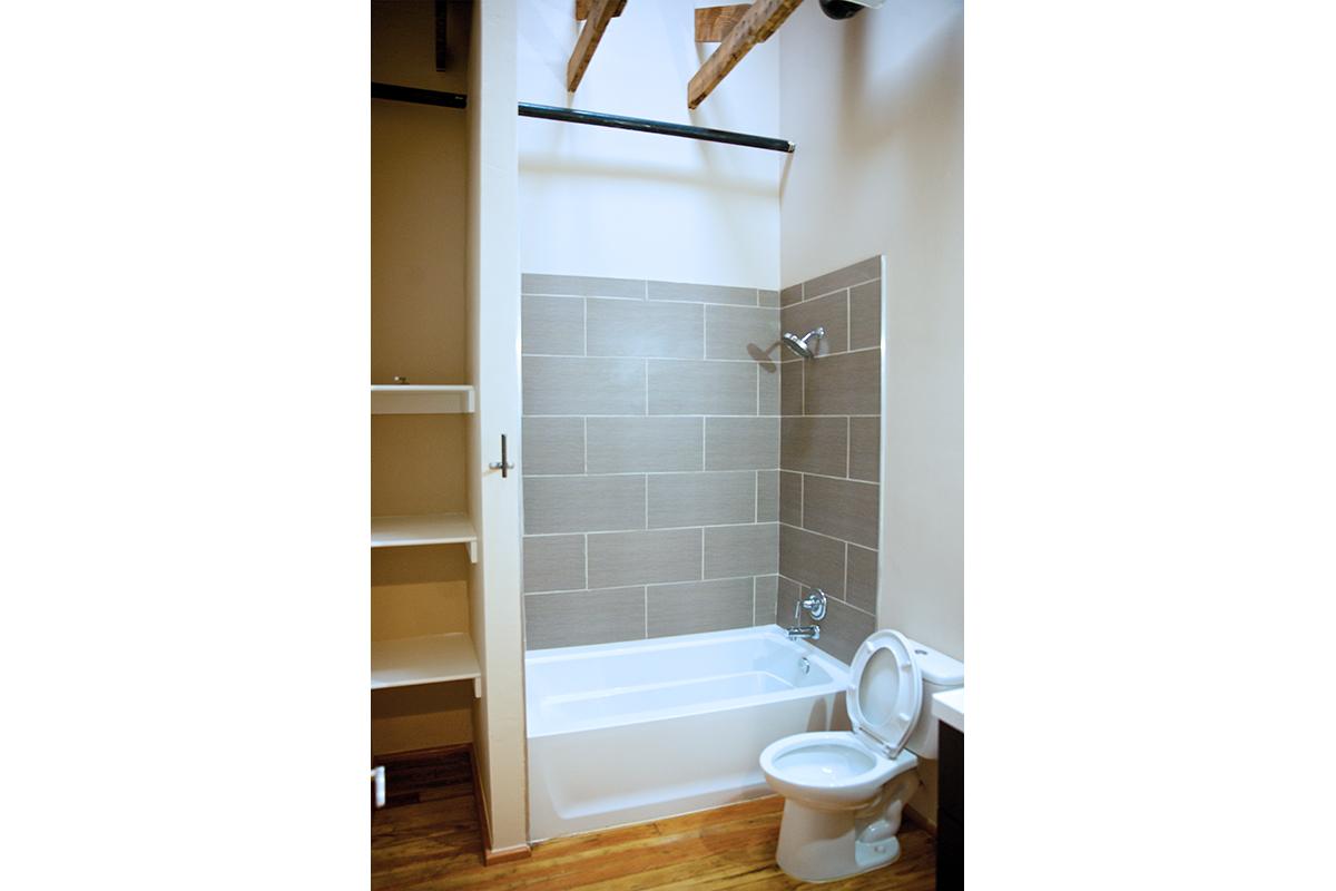 a white tub sitting next to a shower