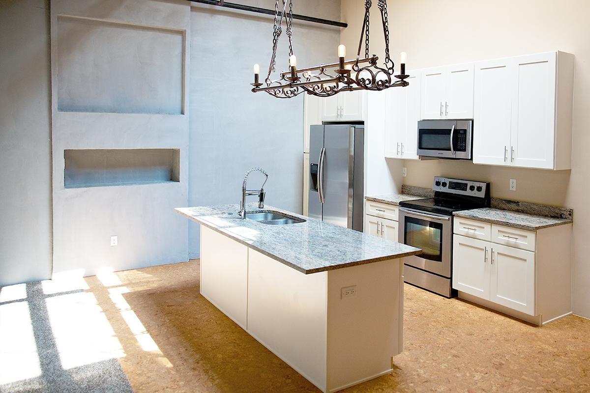 a kitchen with a sink and a mirror