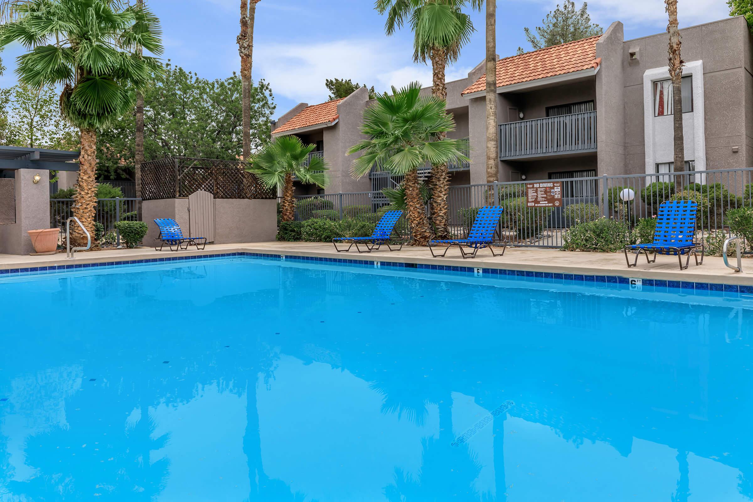 a blue pool of water in front of a house