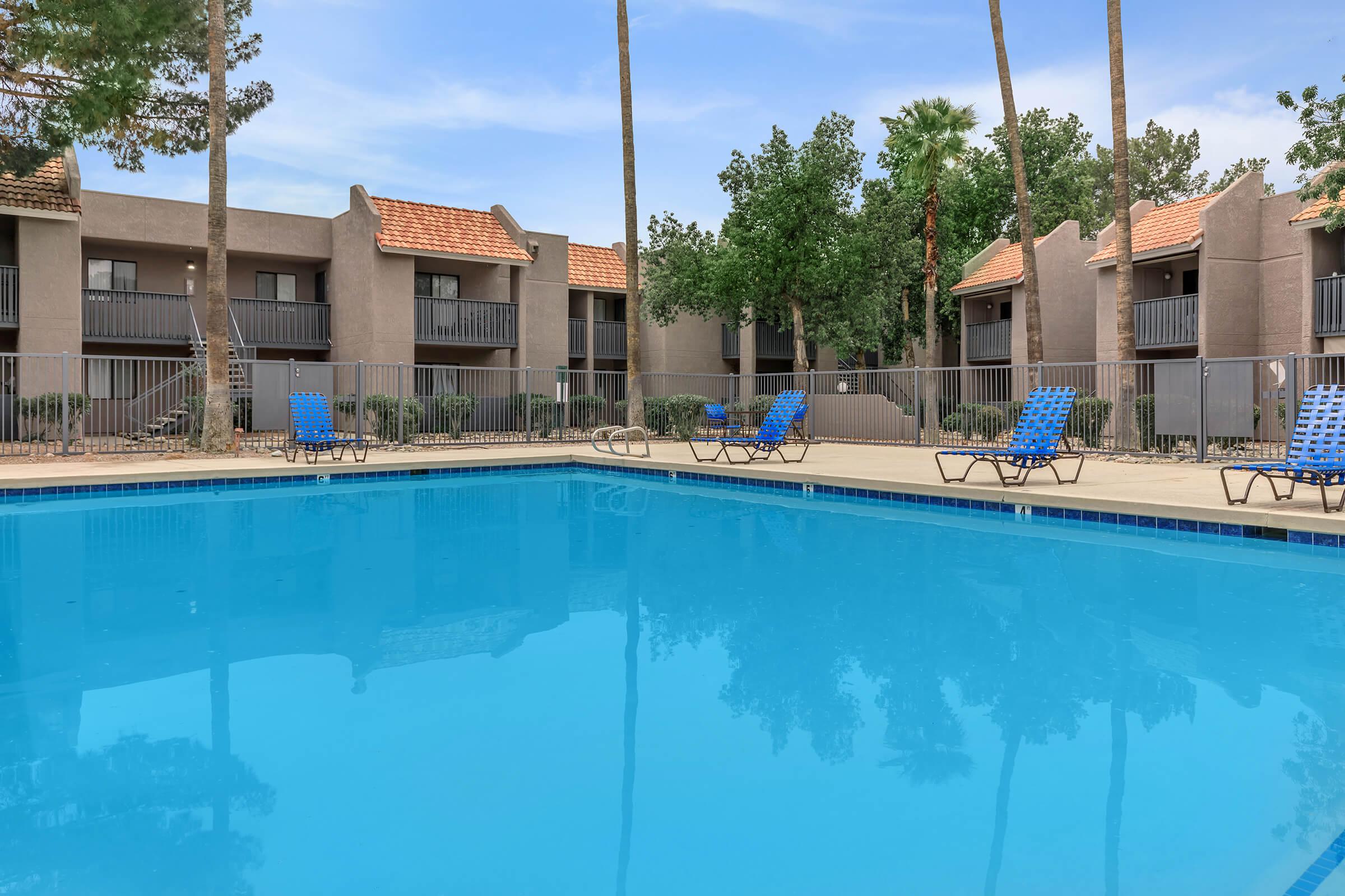 a house with a pool in front of a building