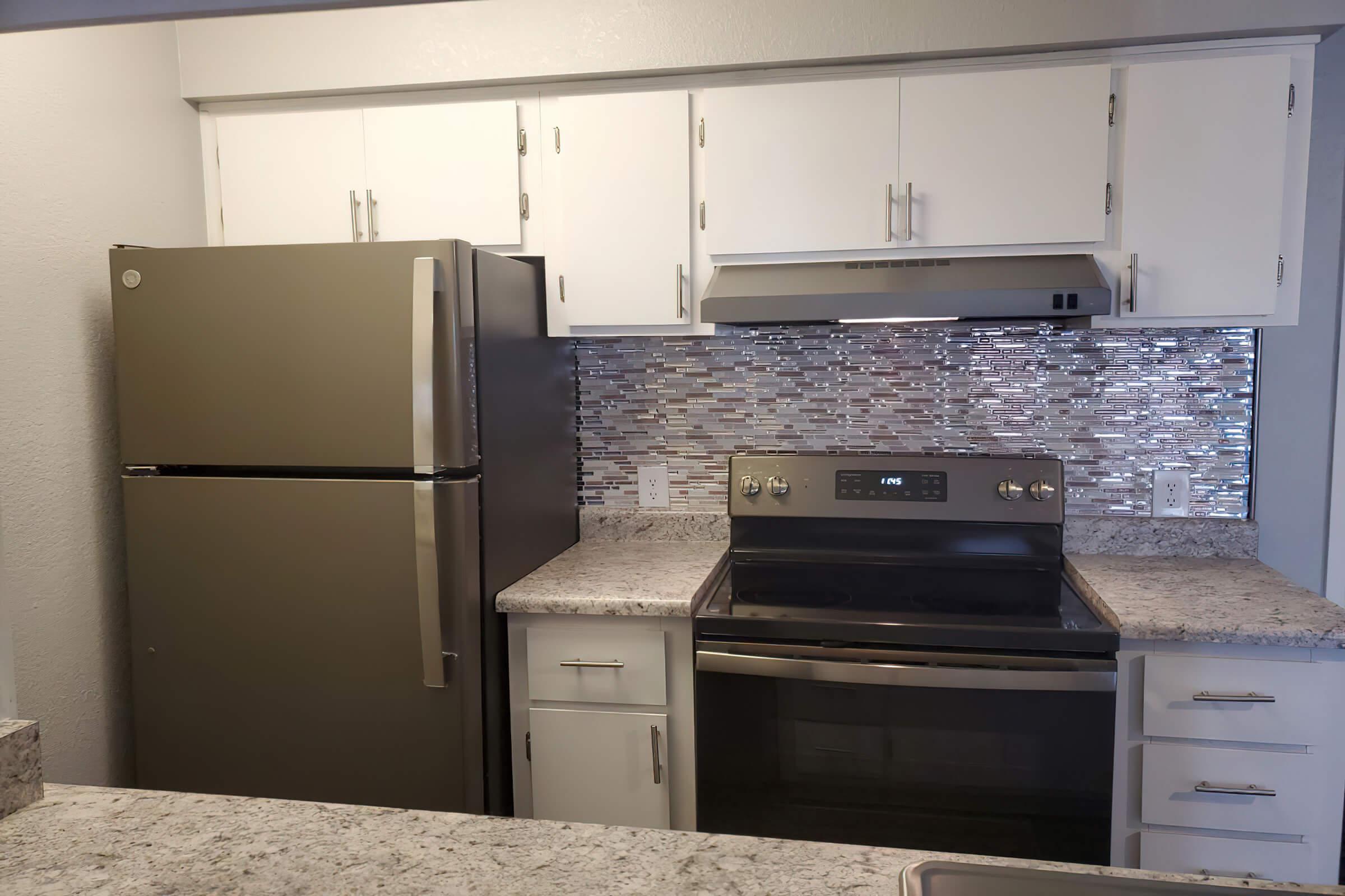 a kitchen with a stove top oven sitting inside of a refrigerator