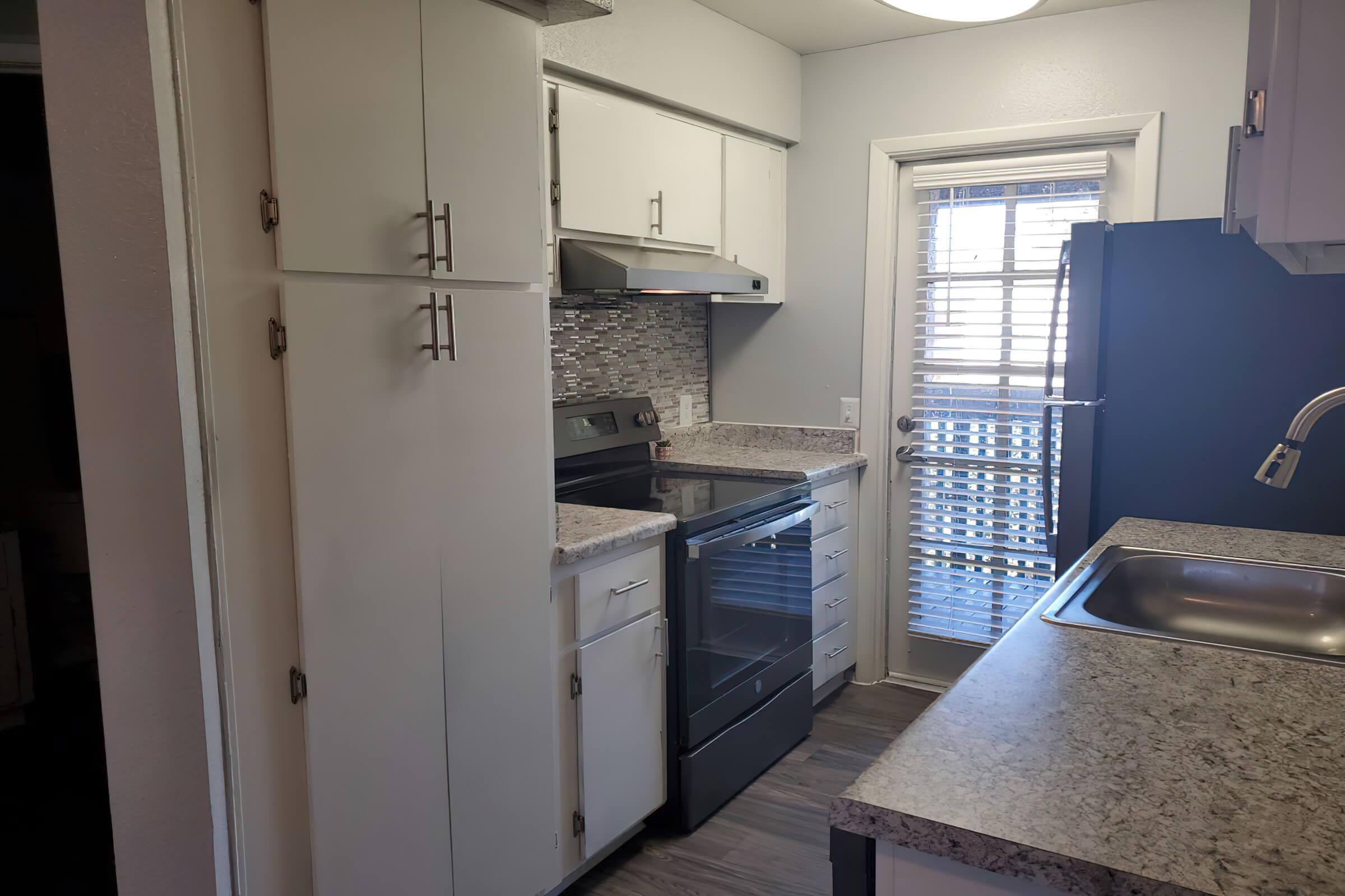 a kitchen with a stove and a sink