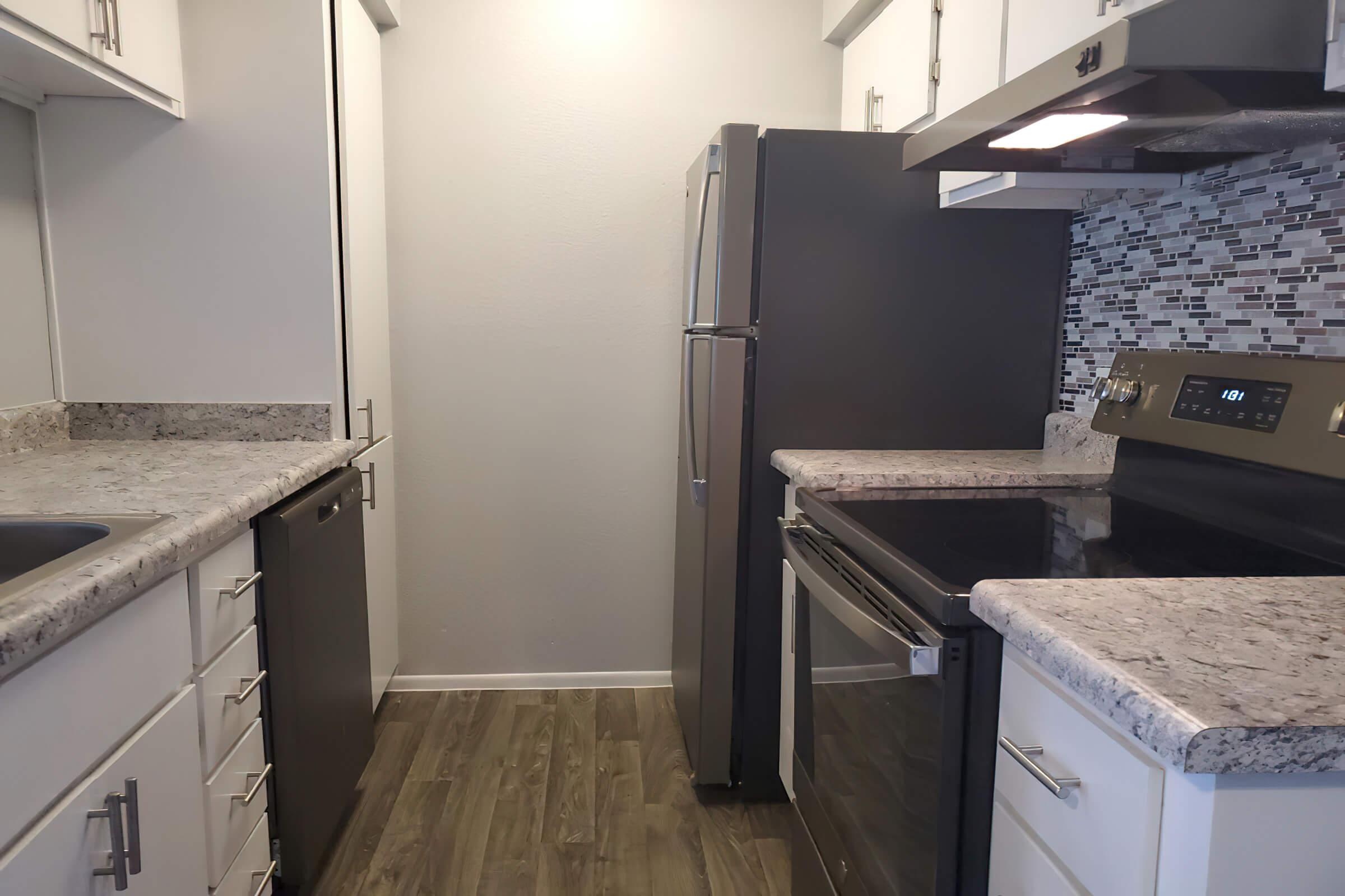 a kitchen with a sink and a mirror