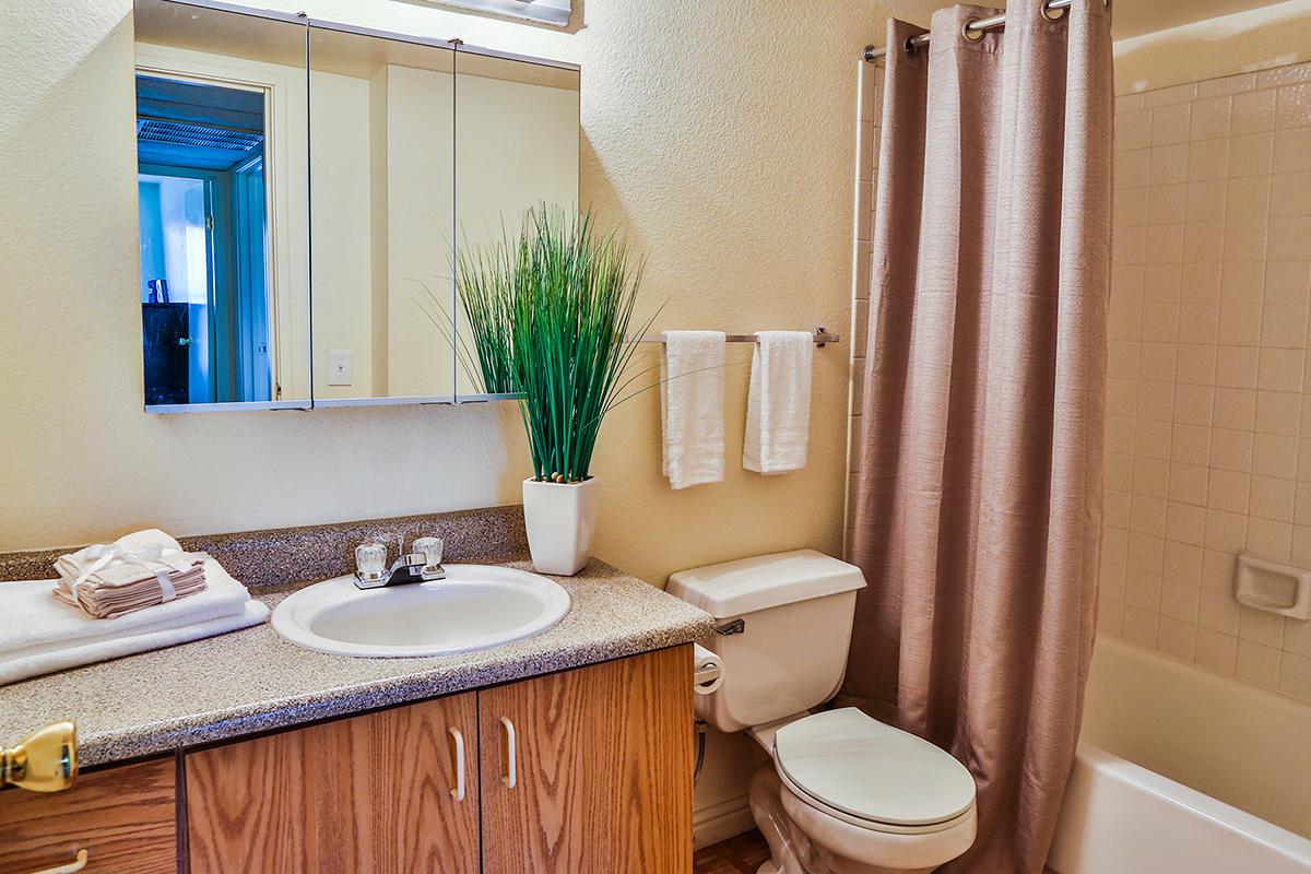 a white tub sitting next to a sink