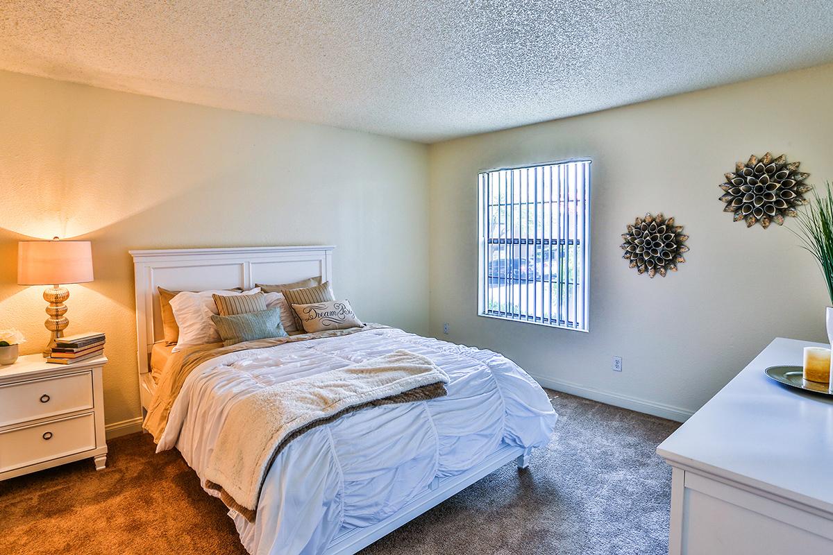 a bedroom with a bed in a room