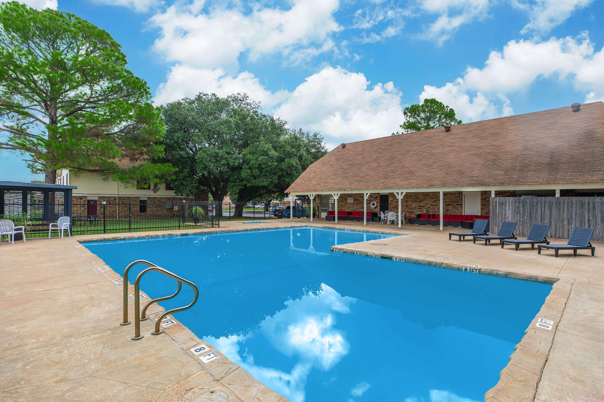 a house with a pool outside of a building