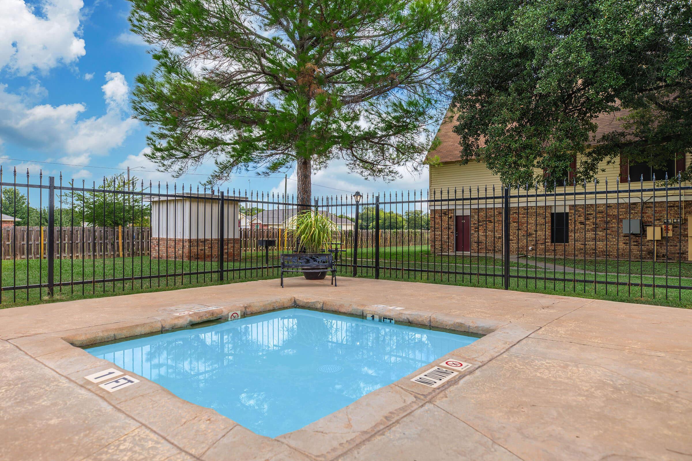 a pool next to a fence