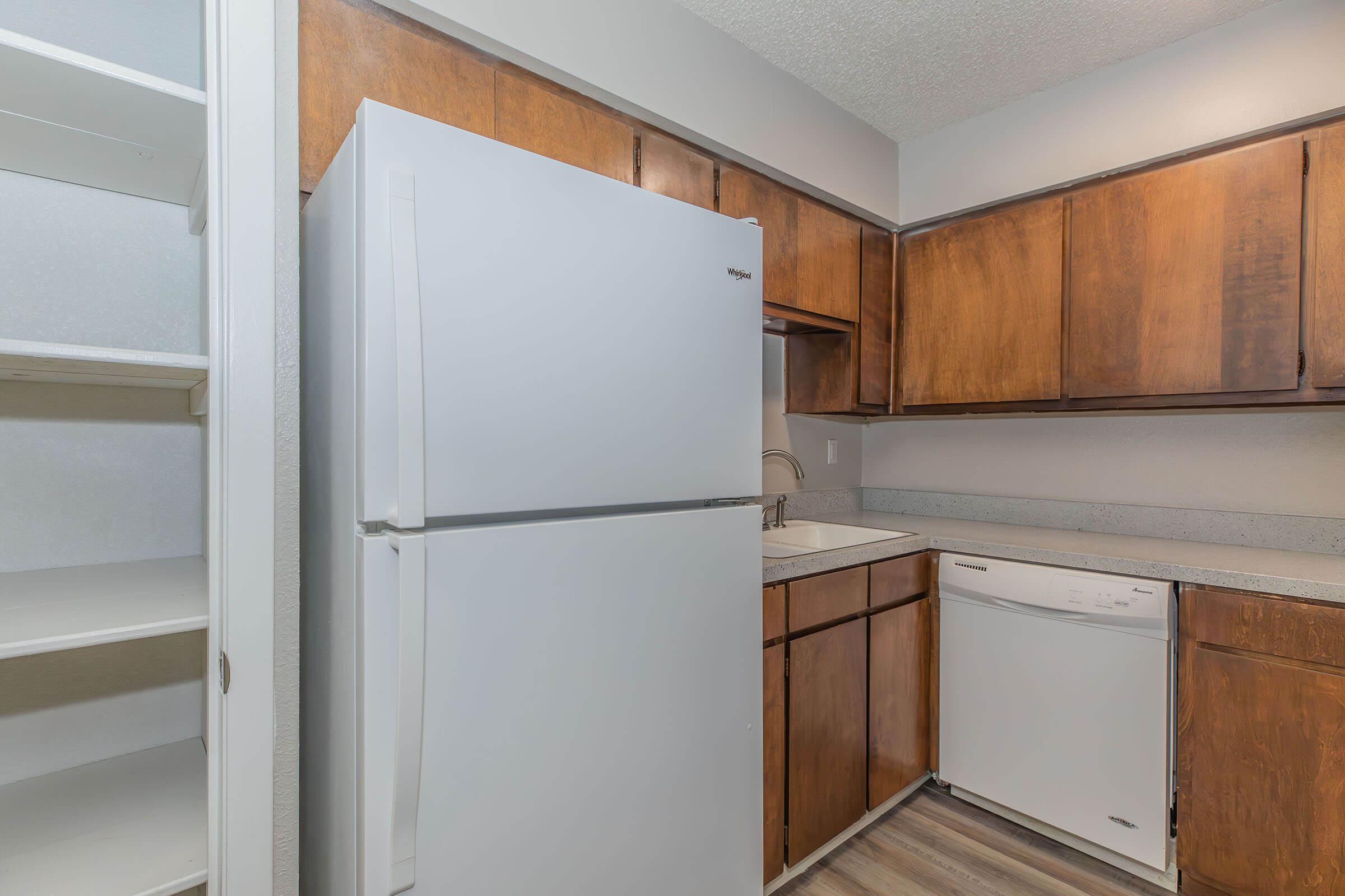 a refrigerator freezer sitting inside of a kitchen