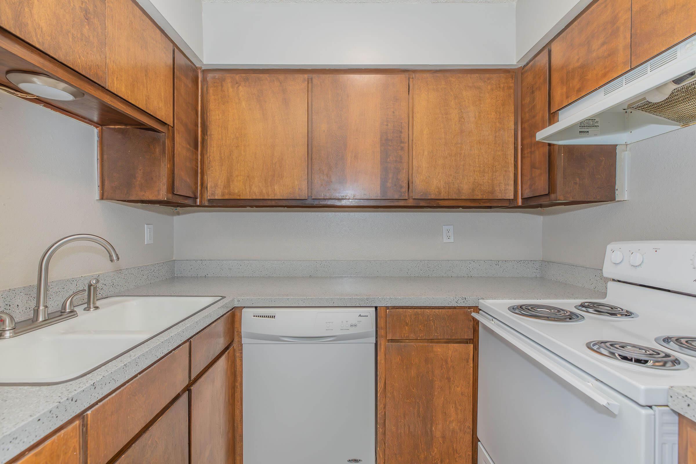 a kitchen with a stove a sink and a microwave