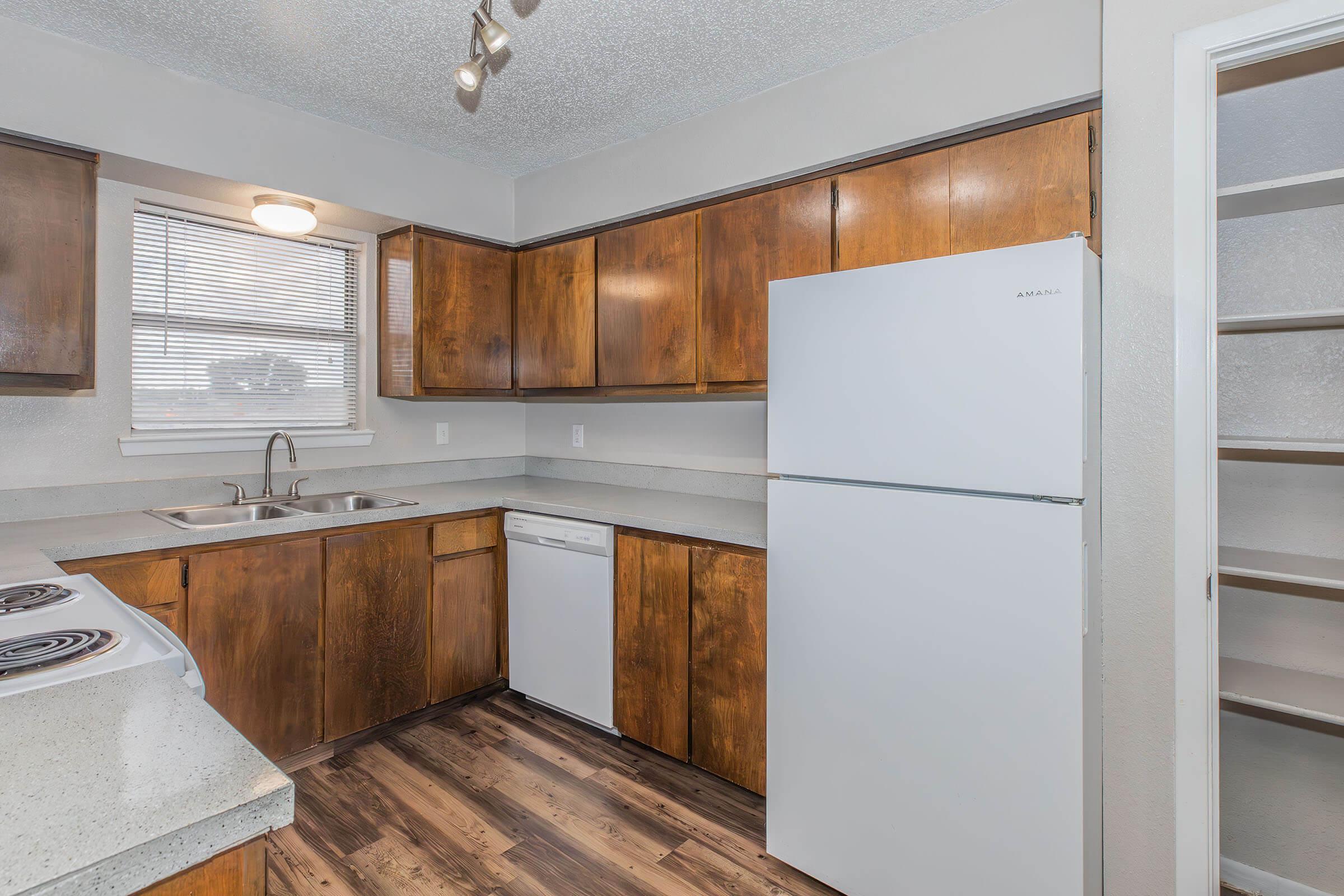 a kitchen with a stove and a refrigerator