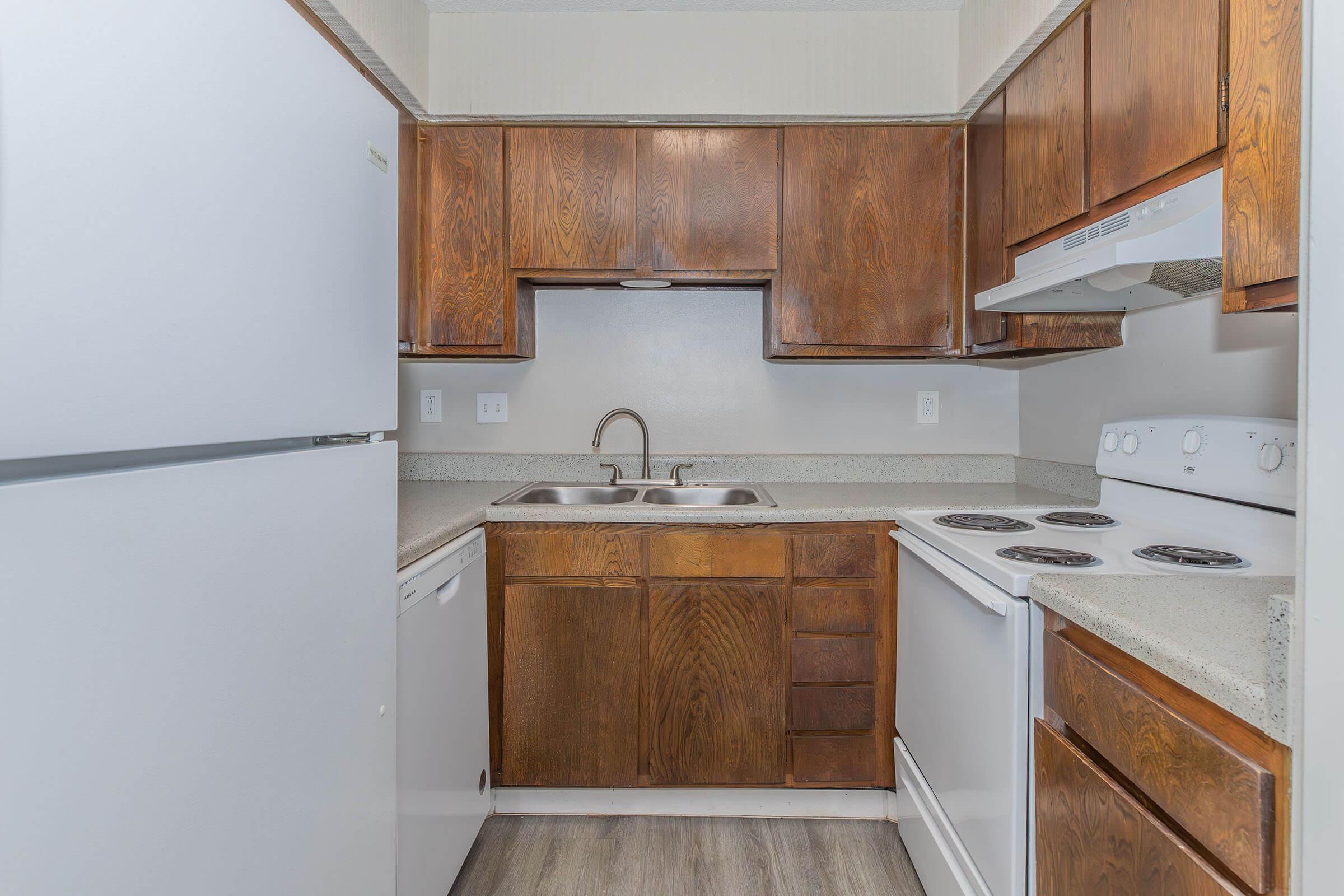 a kitchen with a sink and a refrigerator