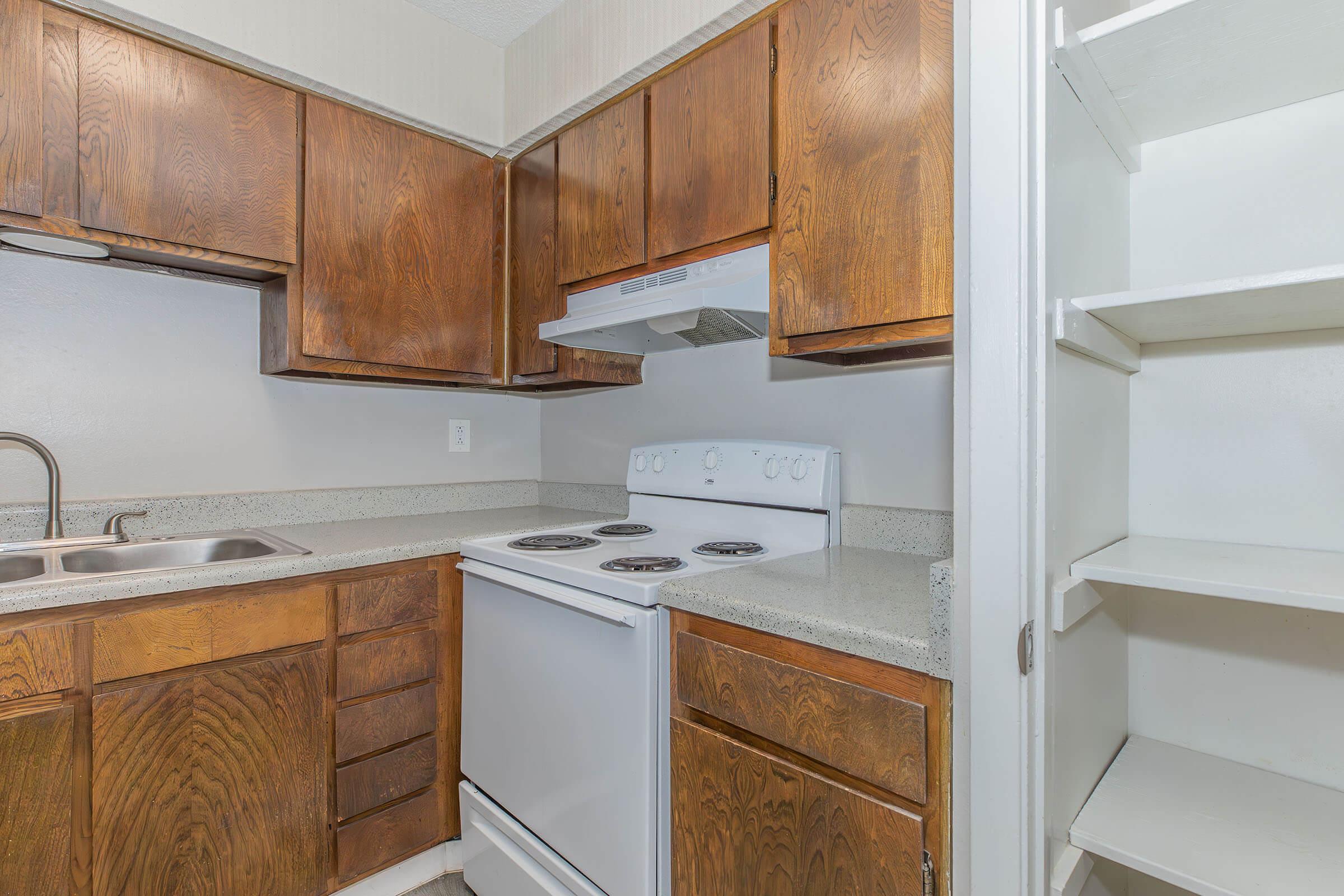 a stove top oven sitting inside of a kitchen