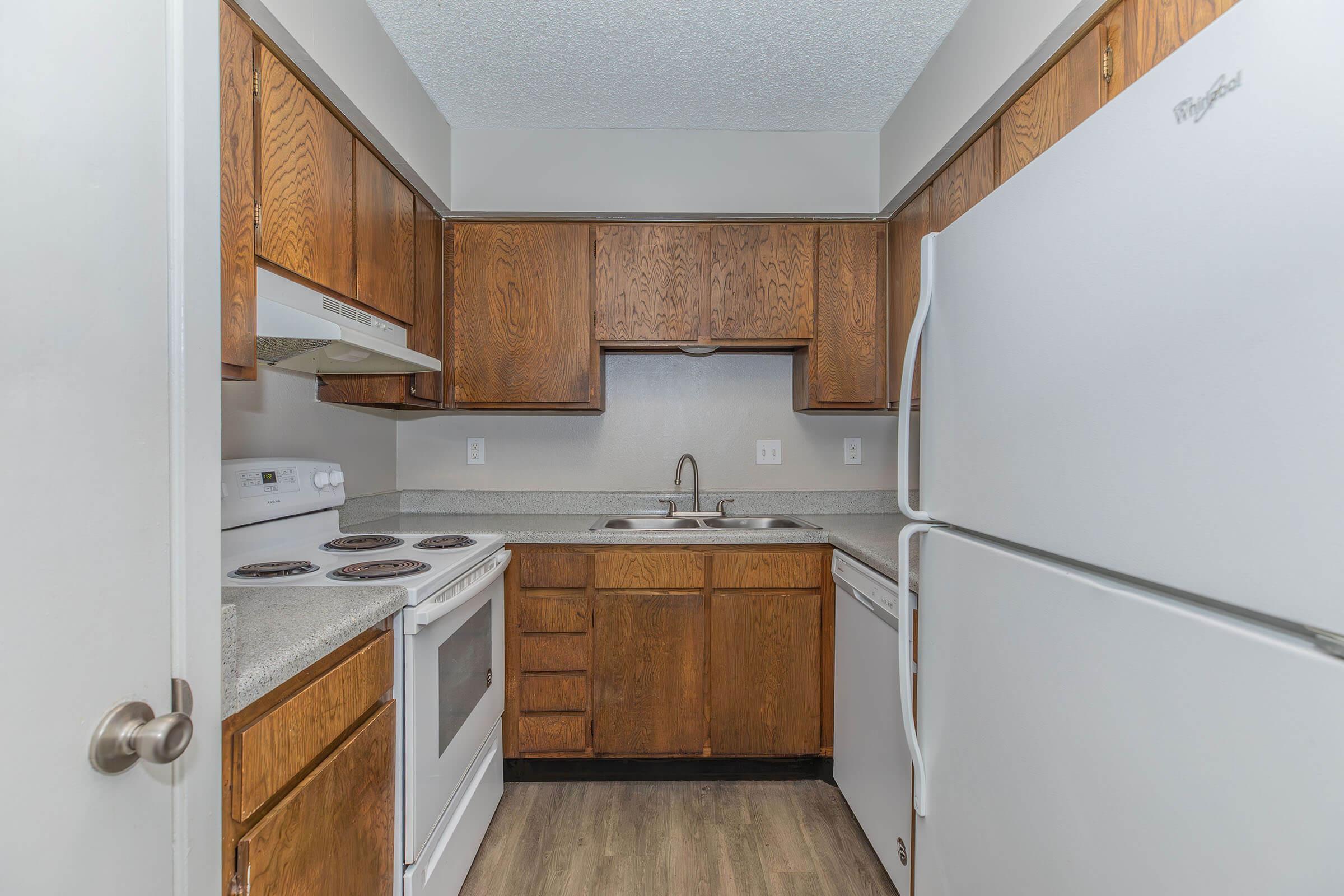 a kitchen with a stove and a refrigerator