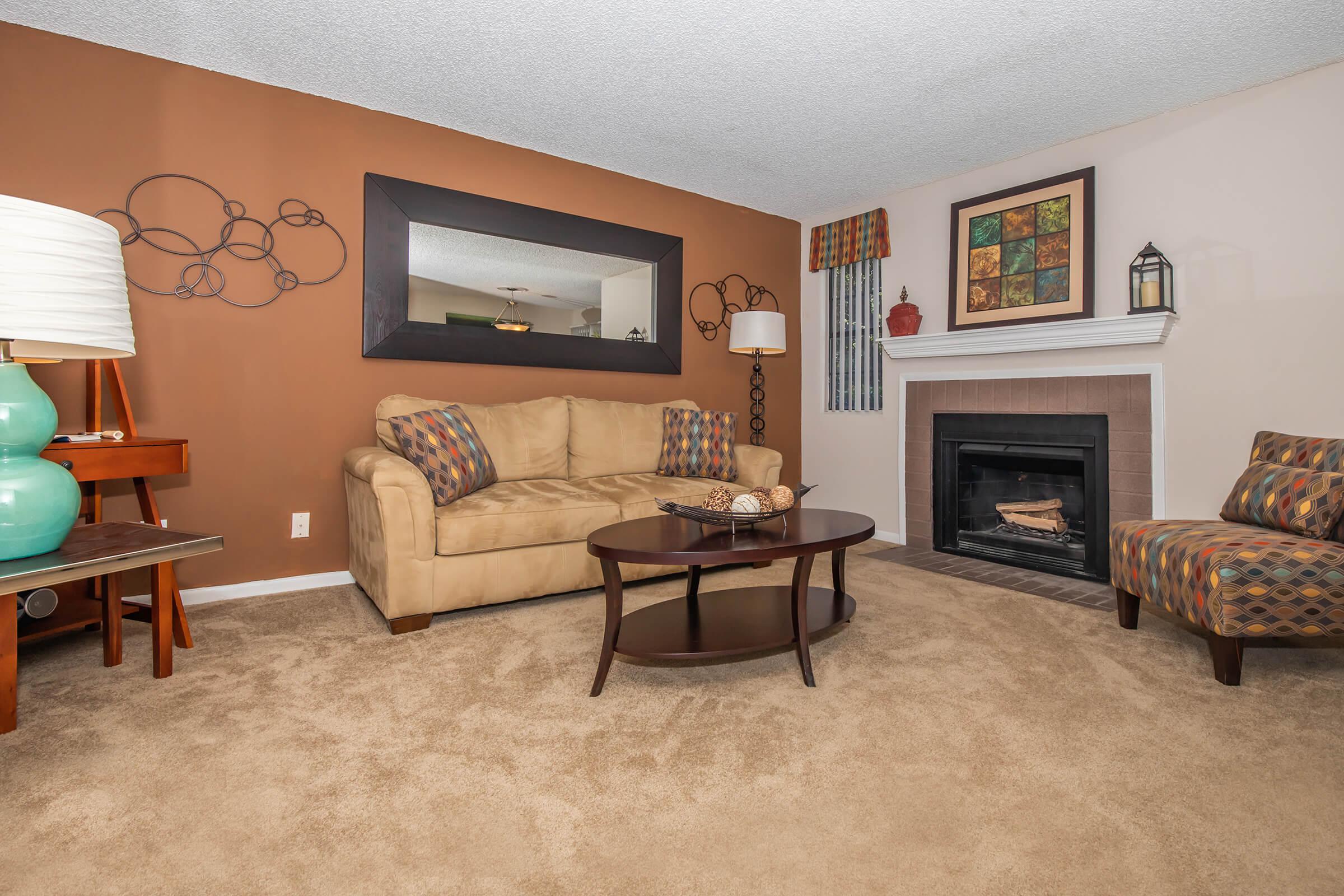 a living room filled with furniture and a fireplace