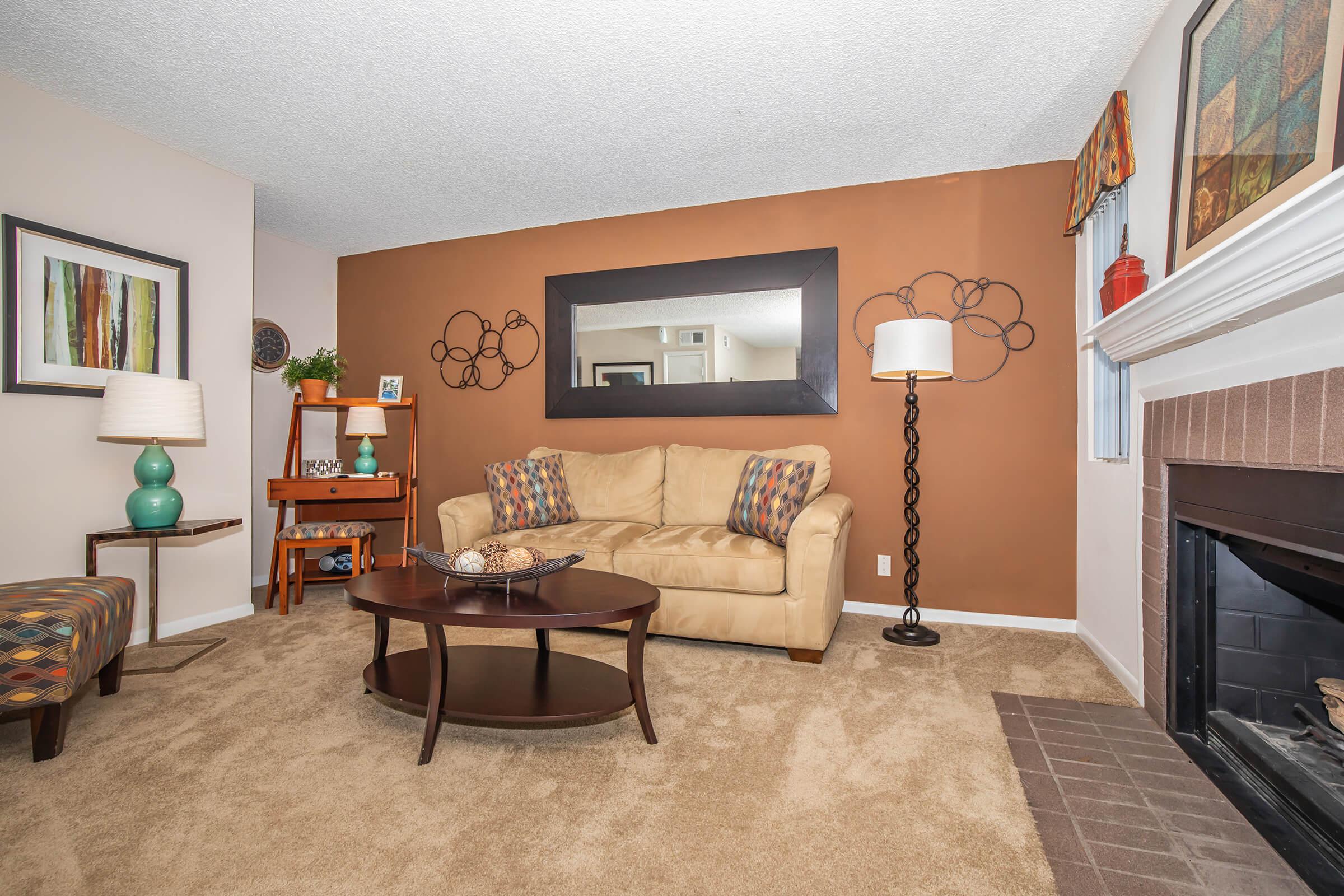 a living room filled with furniture and a fireplace