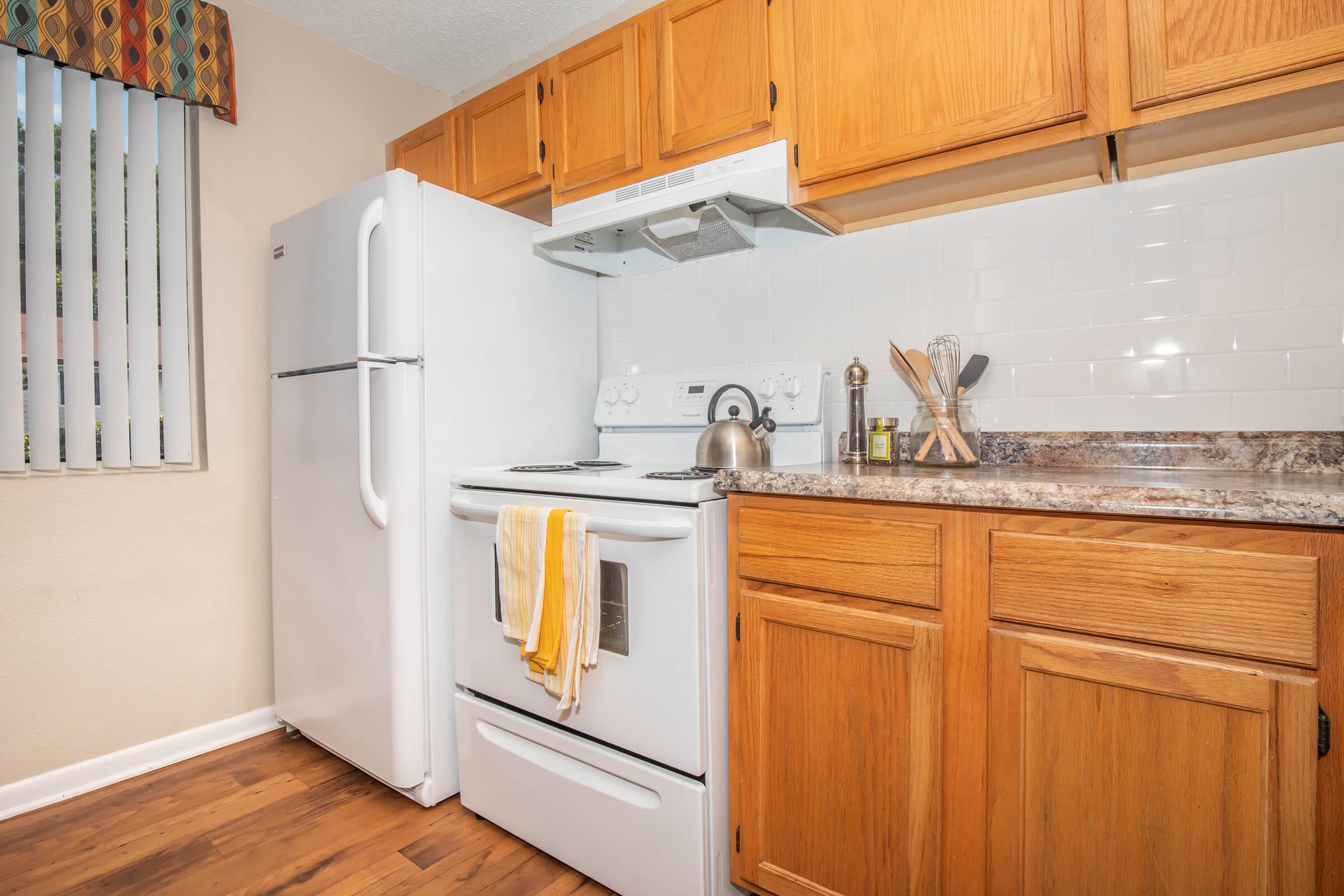 a kitchen with a refrigerator stove and microwave