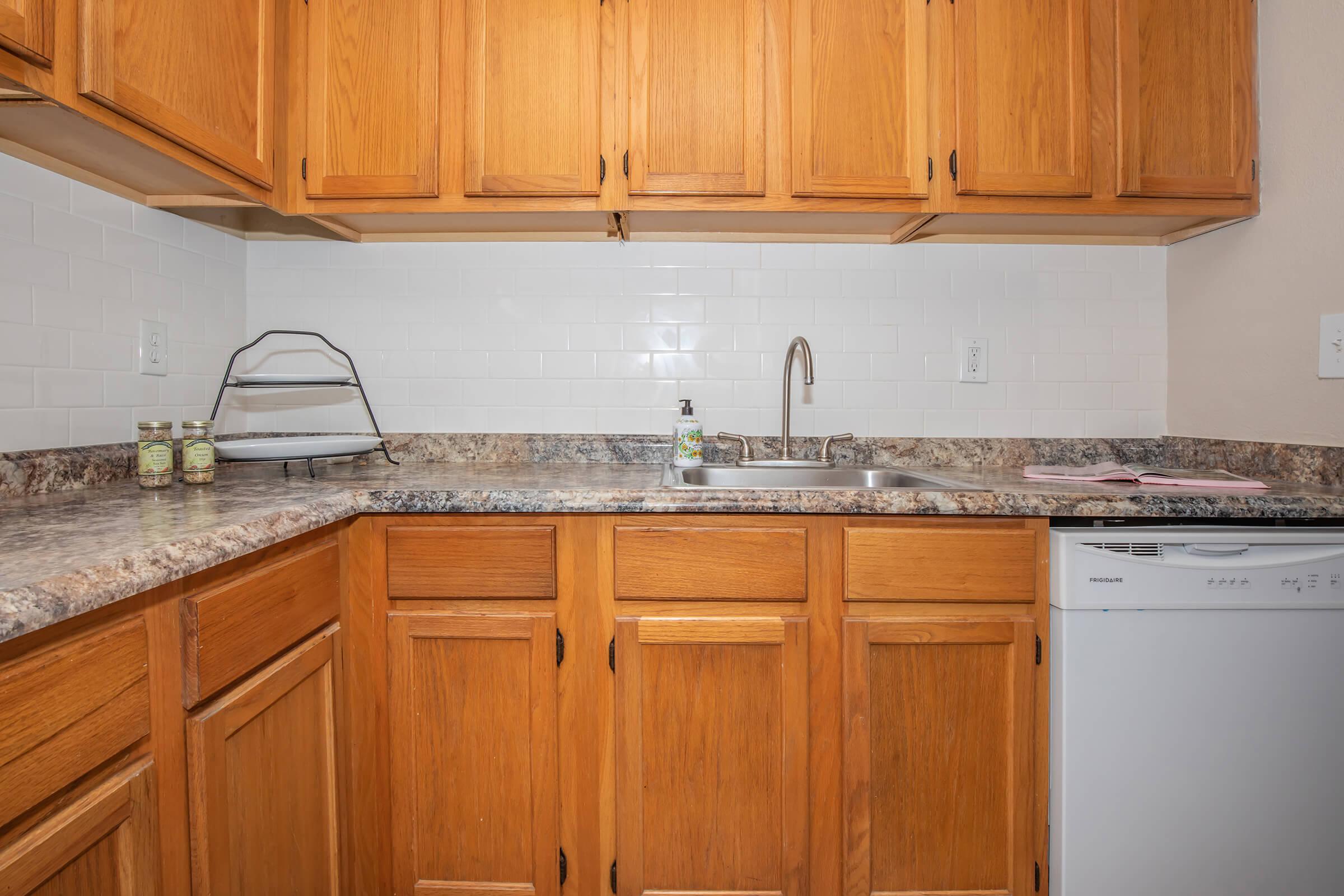 a kitchen with stainless steel appliances and wooden cabinets