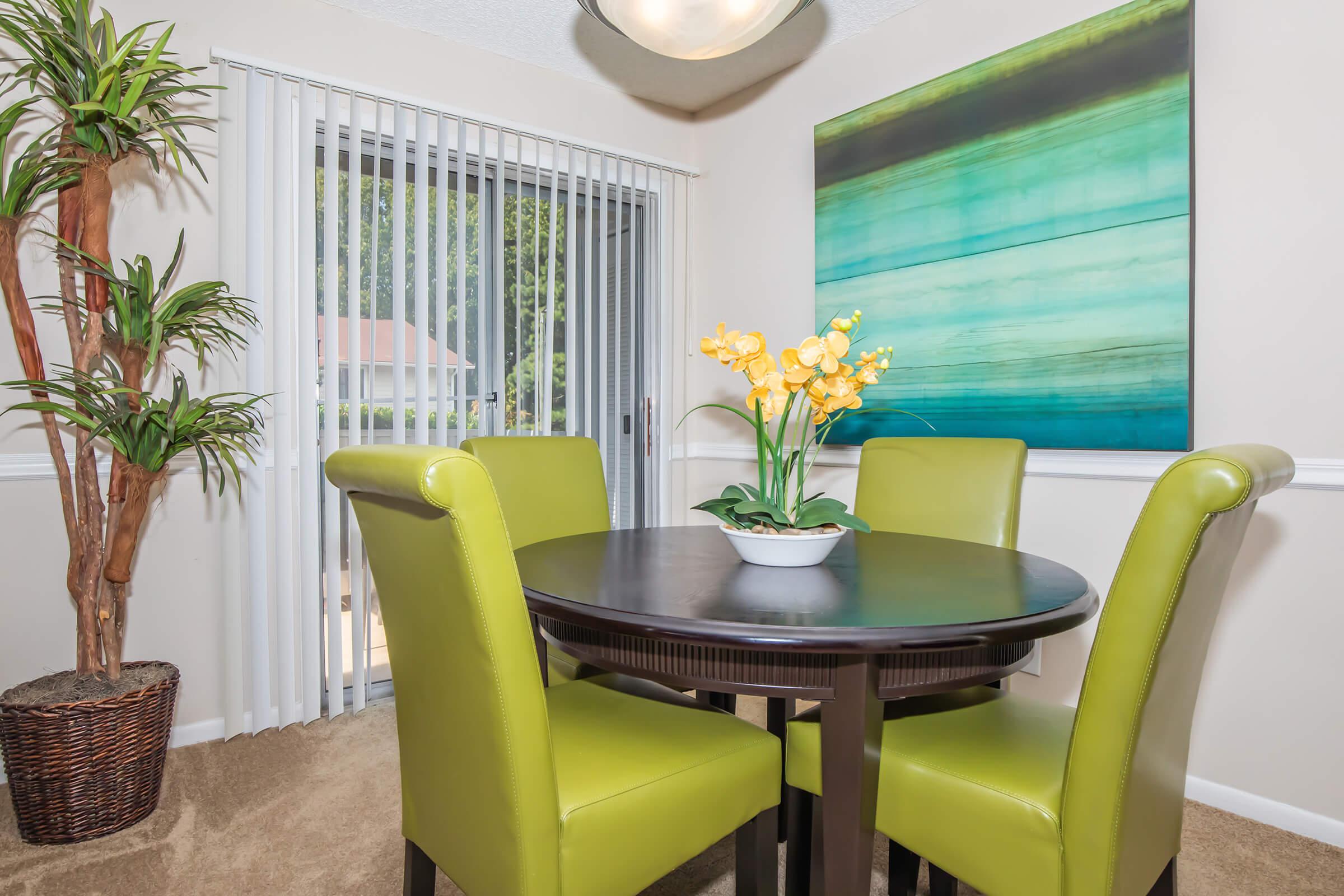 a room filled with furniture and vase of flowers on a table