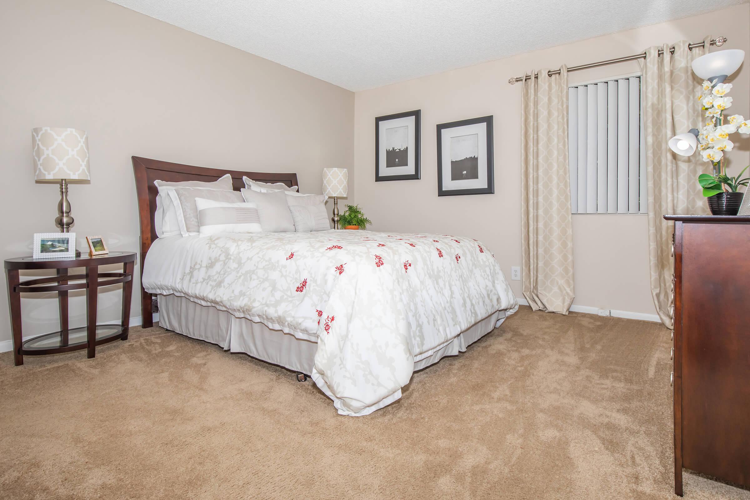 a bedroom with a bed and desk in a room