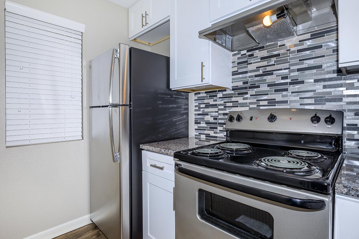 a stove top oven sitting inside of a kitchen