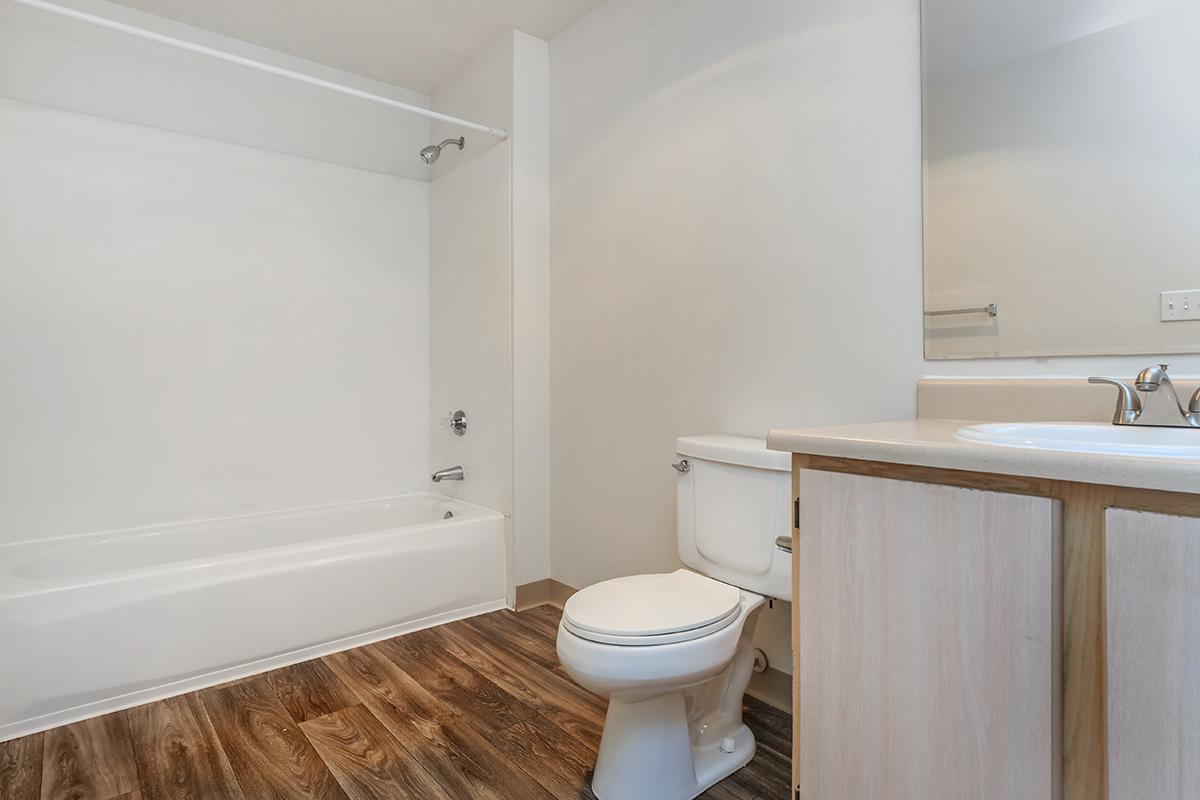 a white tub sitting next to a shower