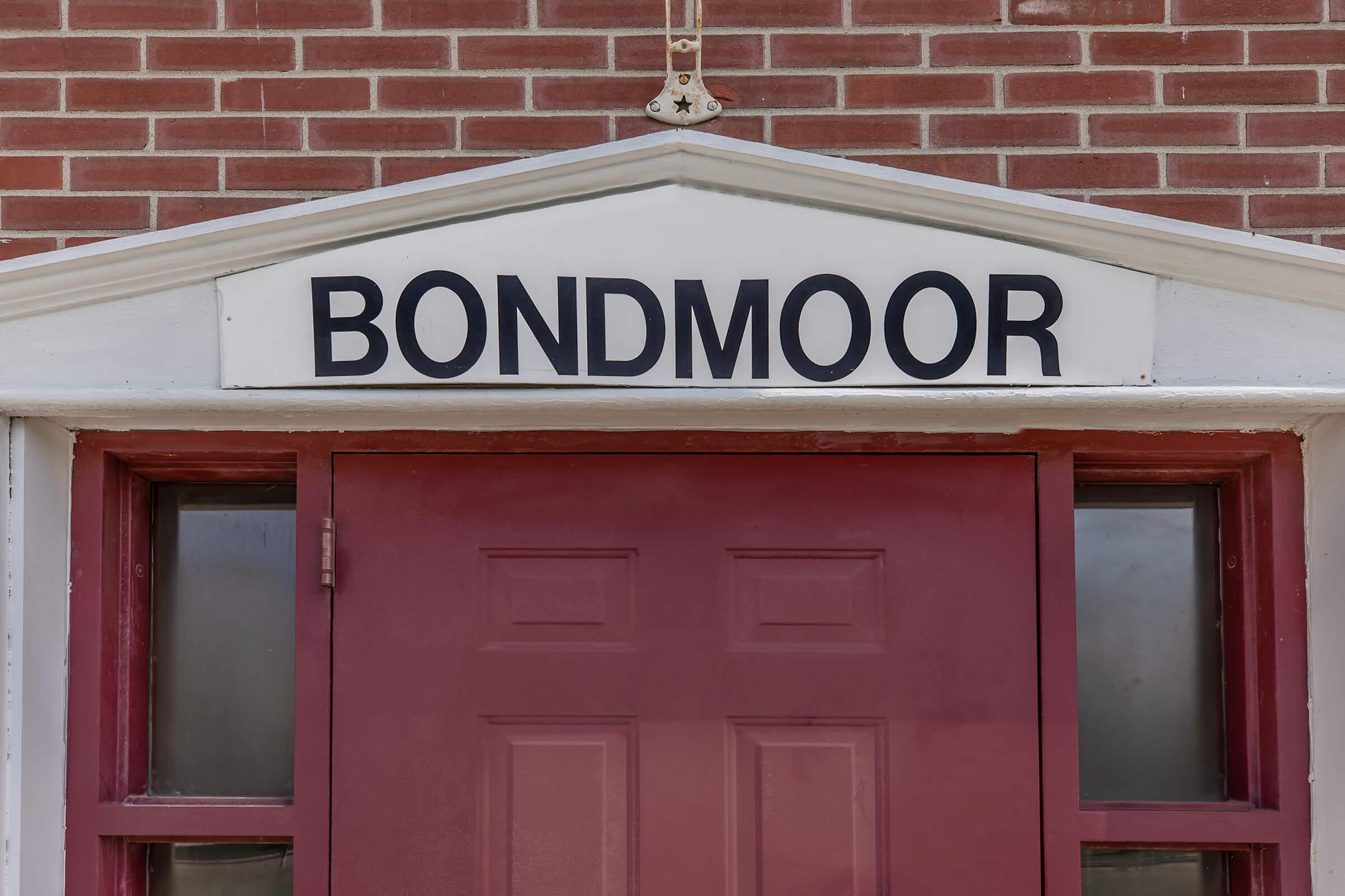 a sign in front of a brick building