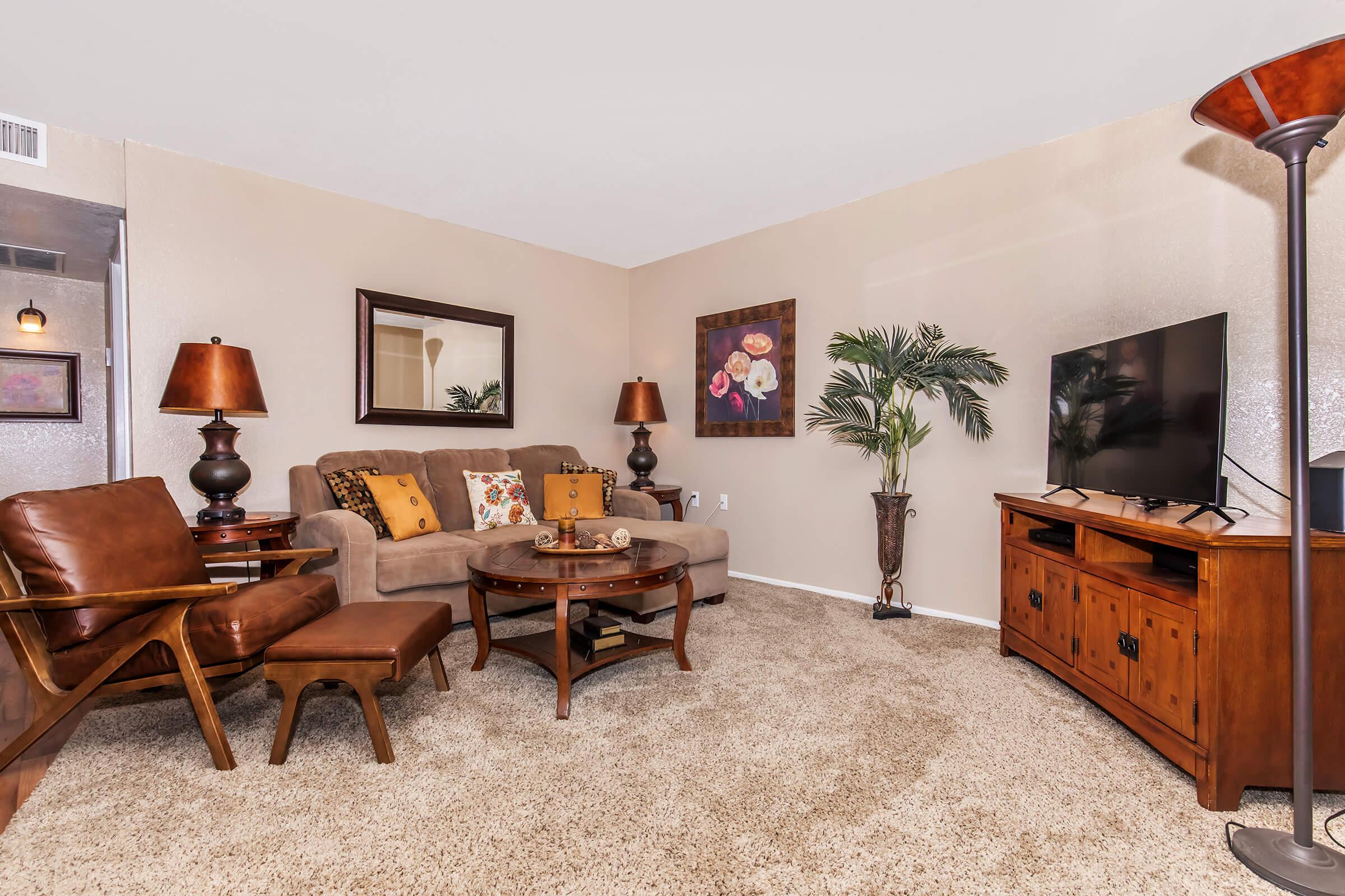 a living room filled with furniture and a tv