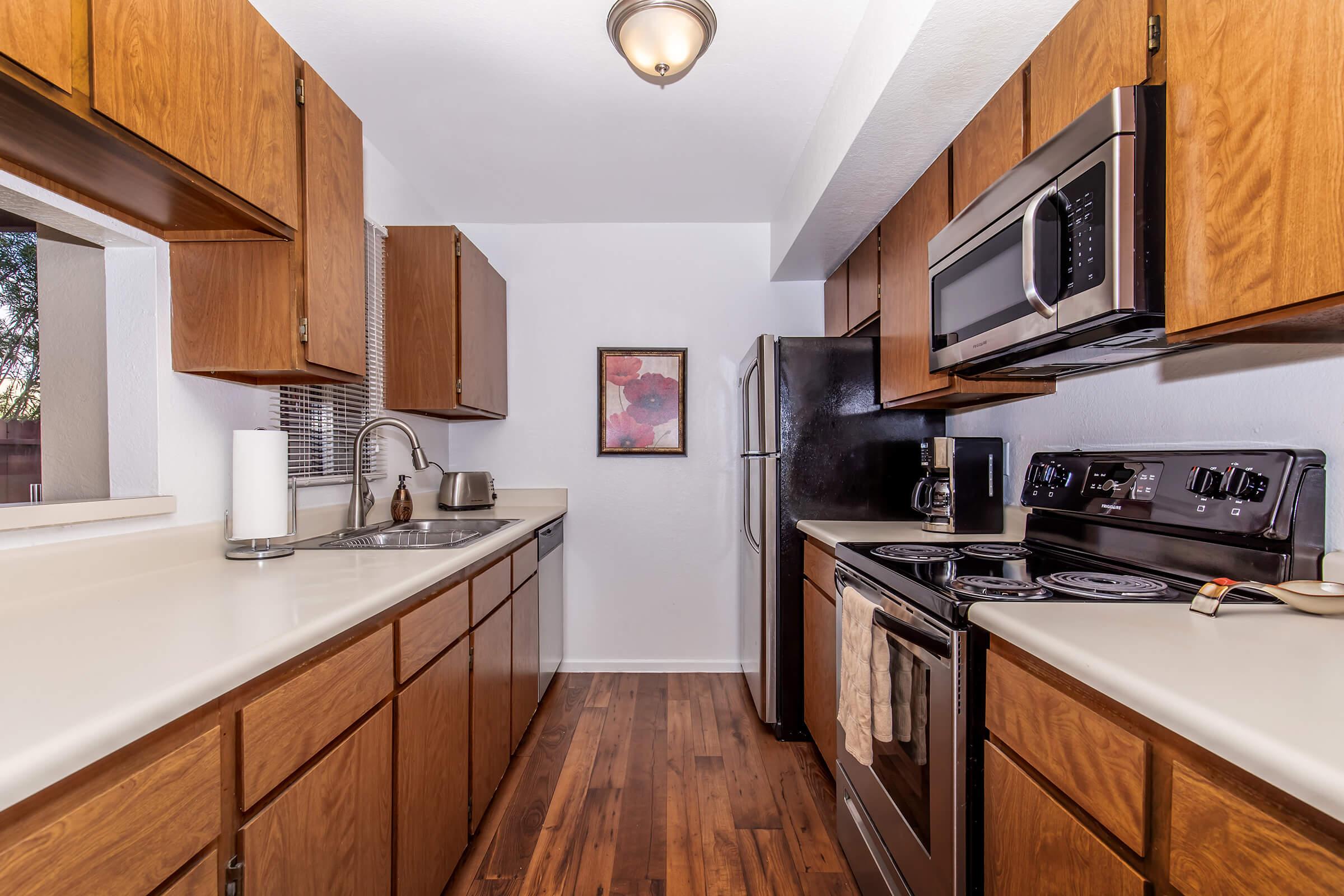 a kitchen with stainless steel appliances and wooden cabinets