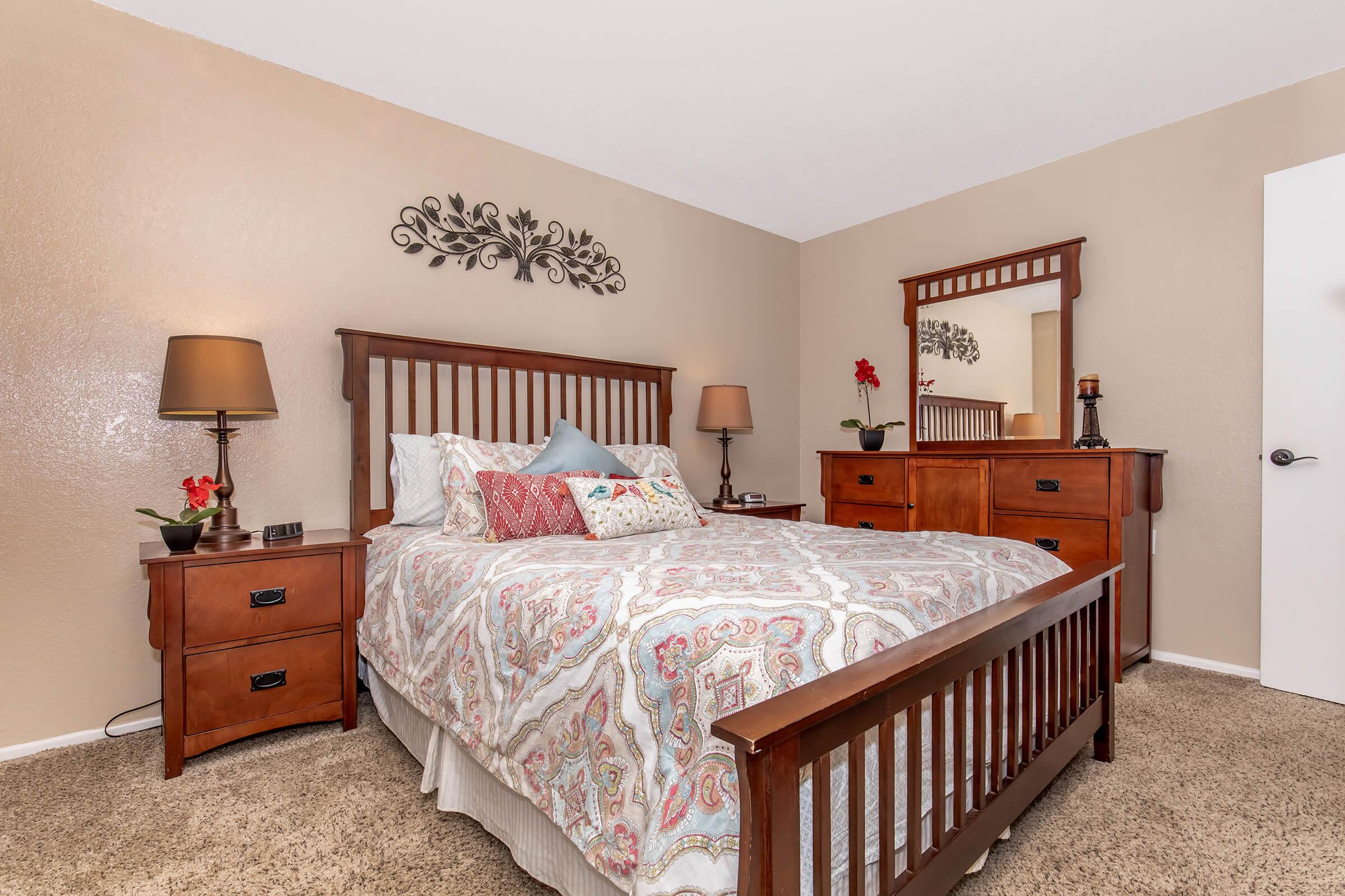 a bedroom with a bed and desk in a small room