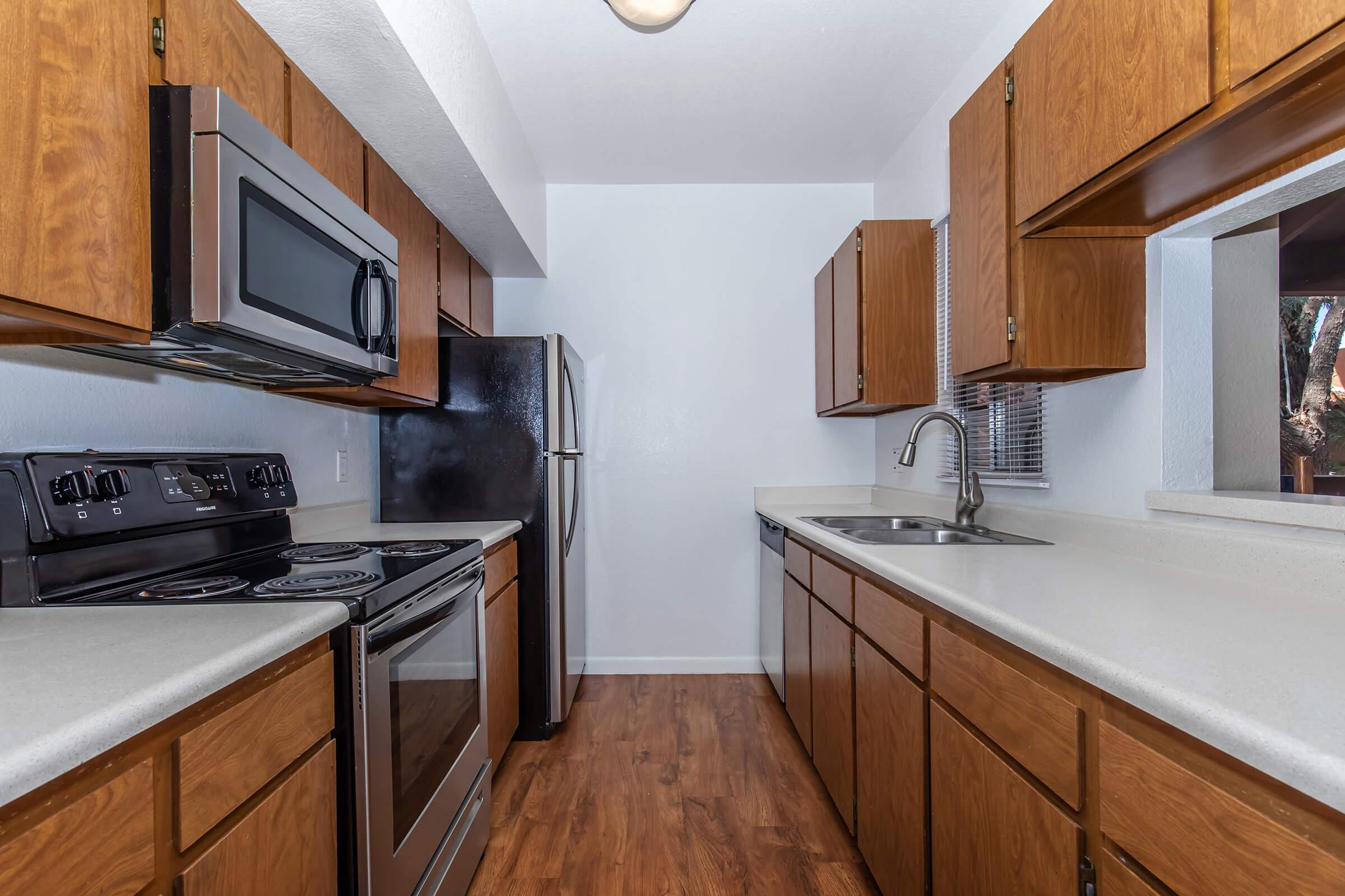 a kitchen with stainless steel appliances and wooden cabinets