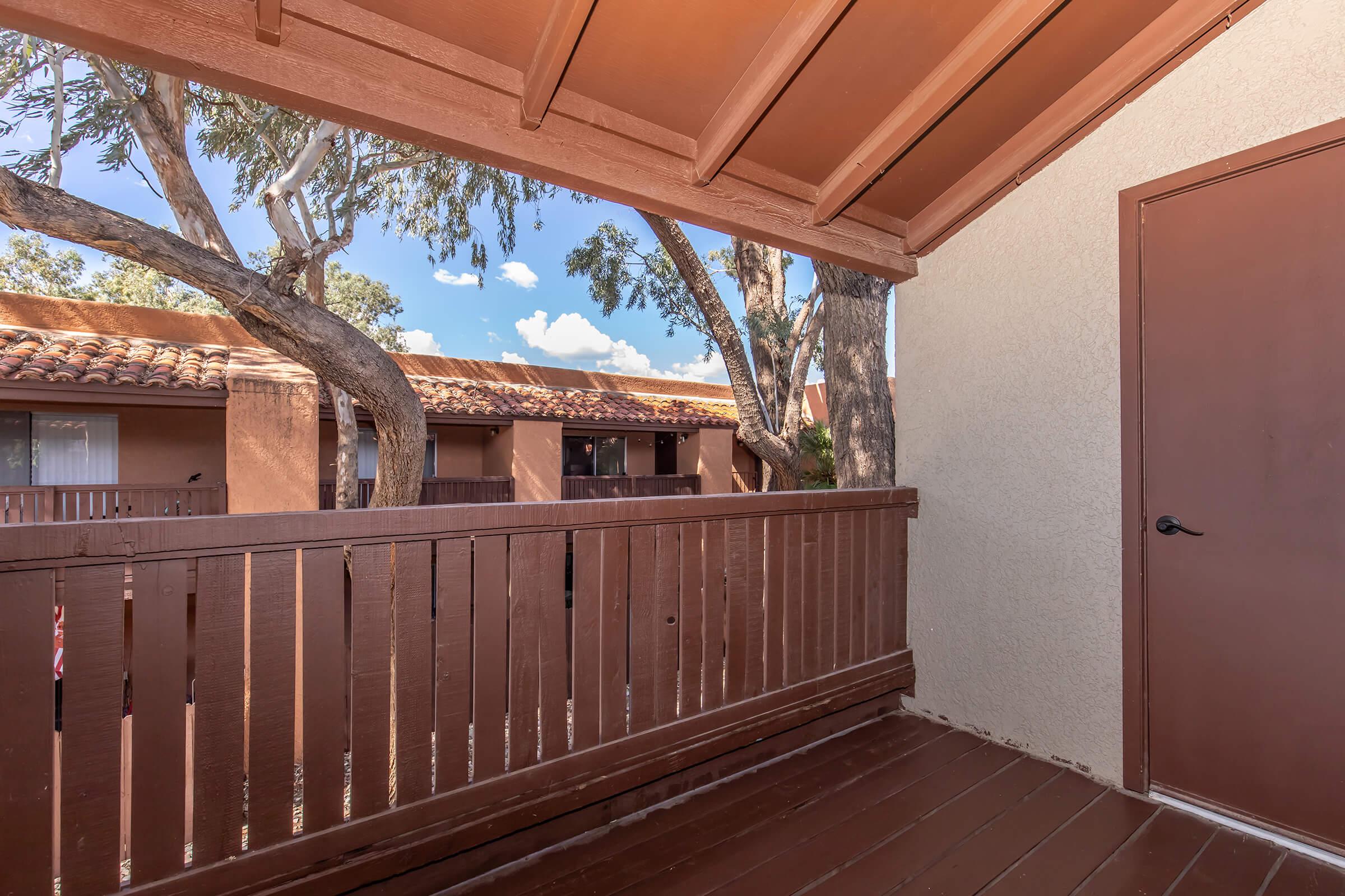 a wooden bench sitting next to a building