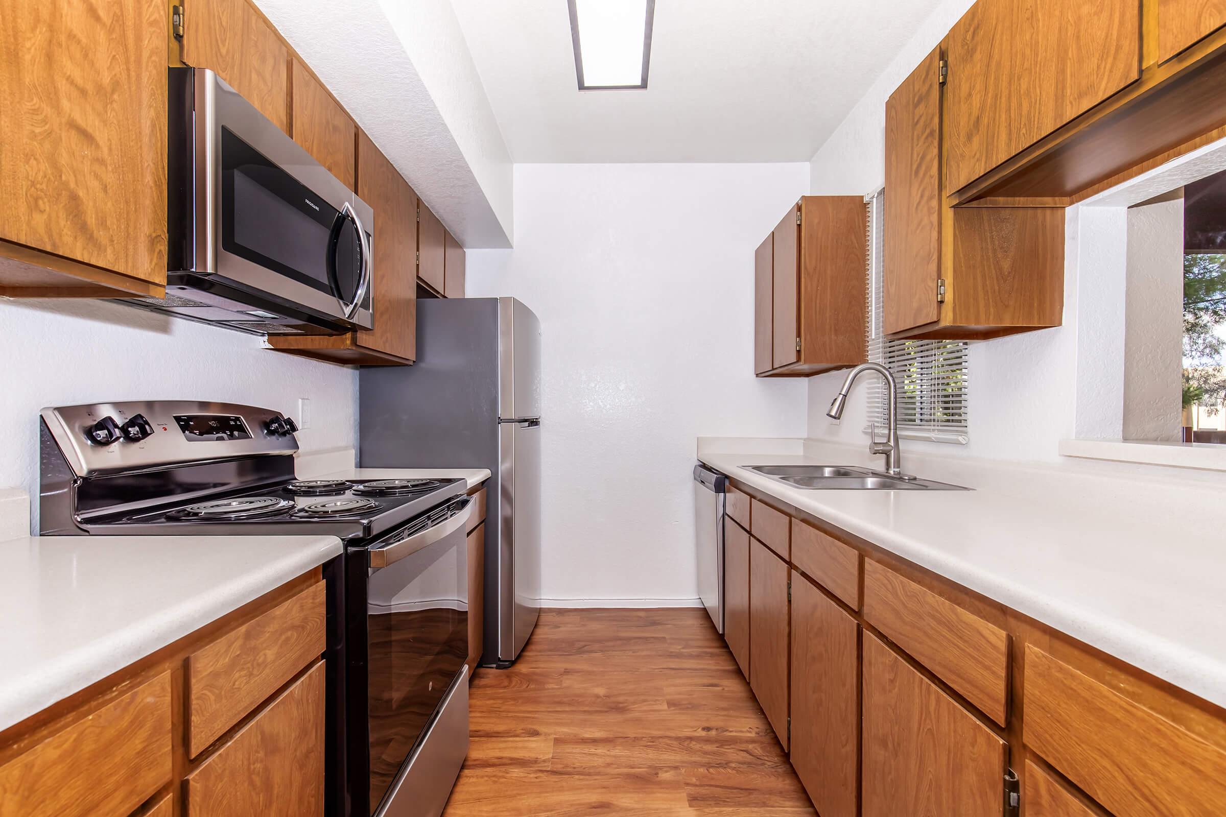 a kitchen with stainless steel appliances and wooden cabinets