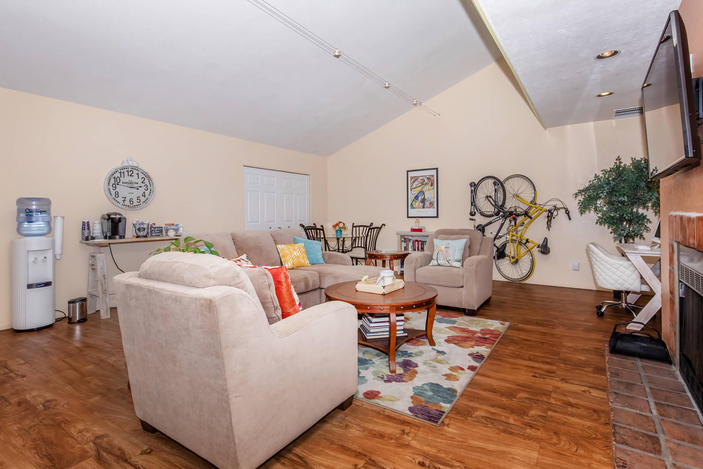 a living room filled with furniture and a wood floor