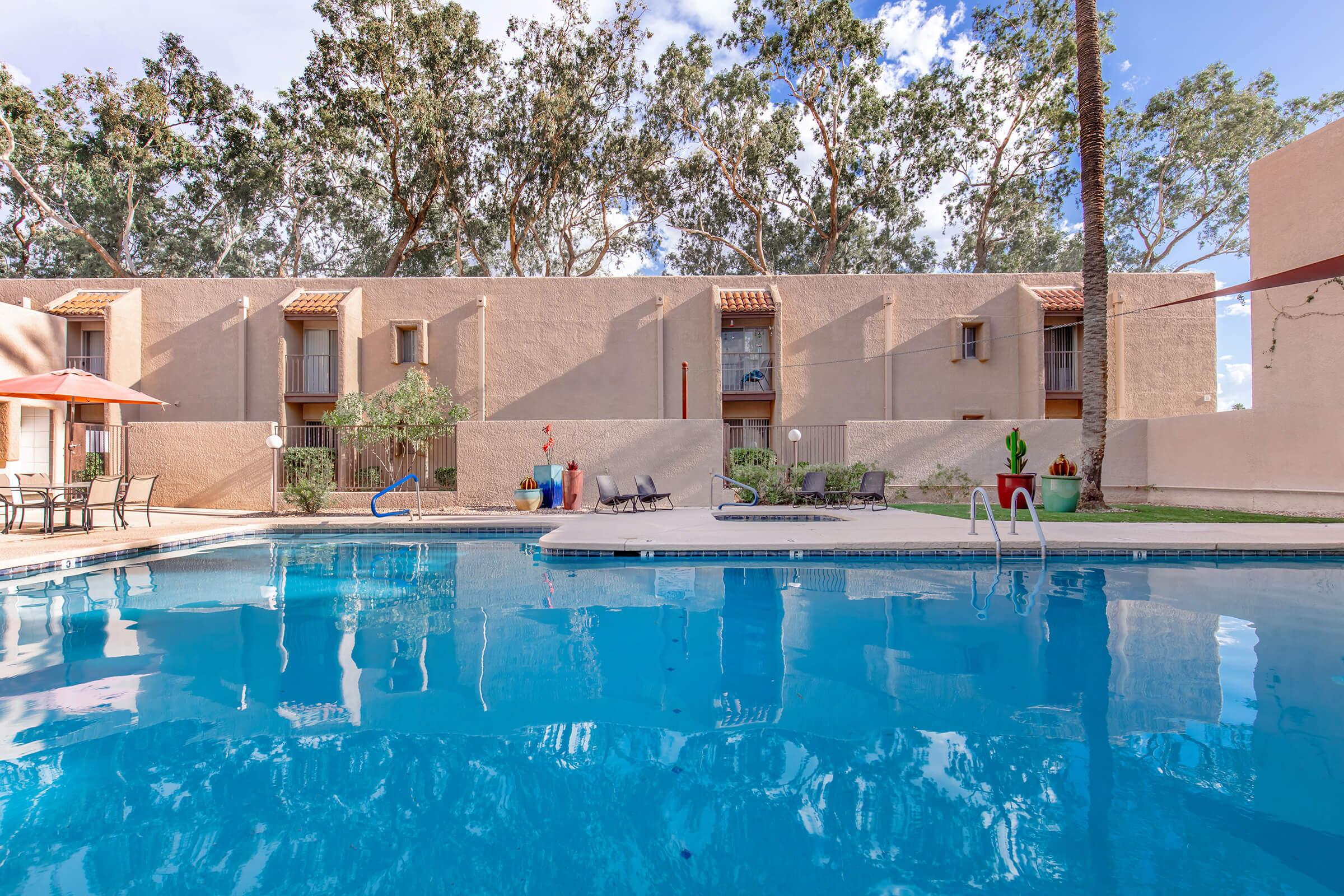 a house with a pool in front of a building