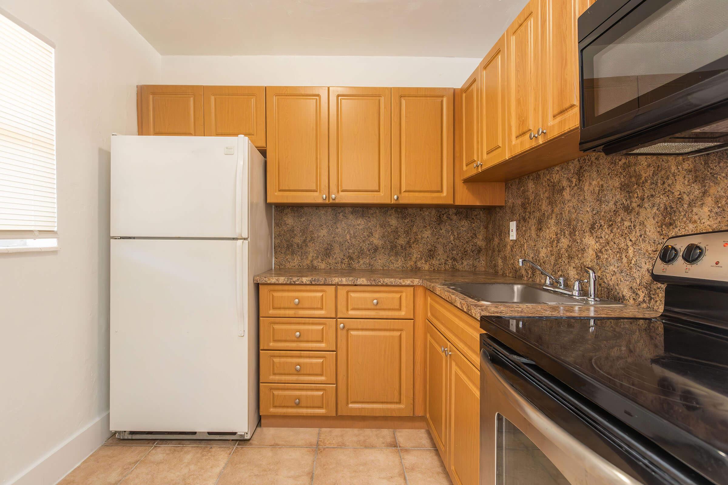 a kitchen with stainless steel appliances and wooden cabinets