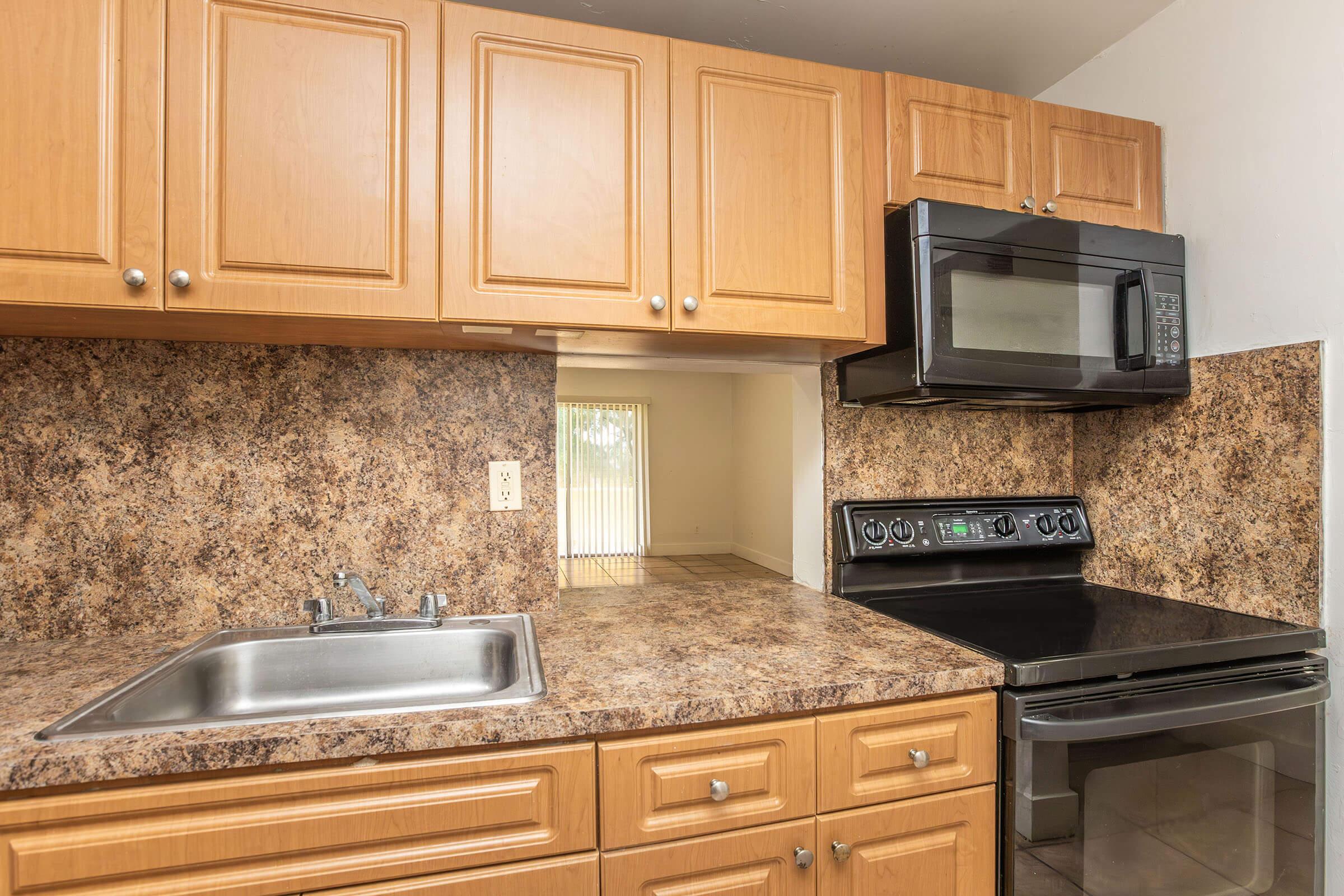 a kitchen with stainless steel appliances and wooden cabinets