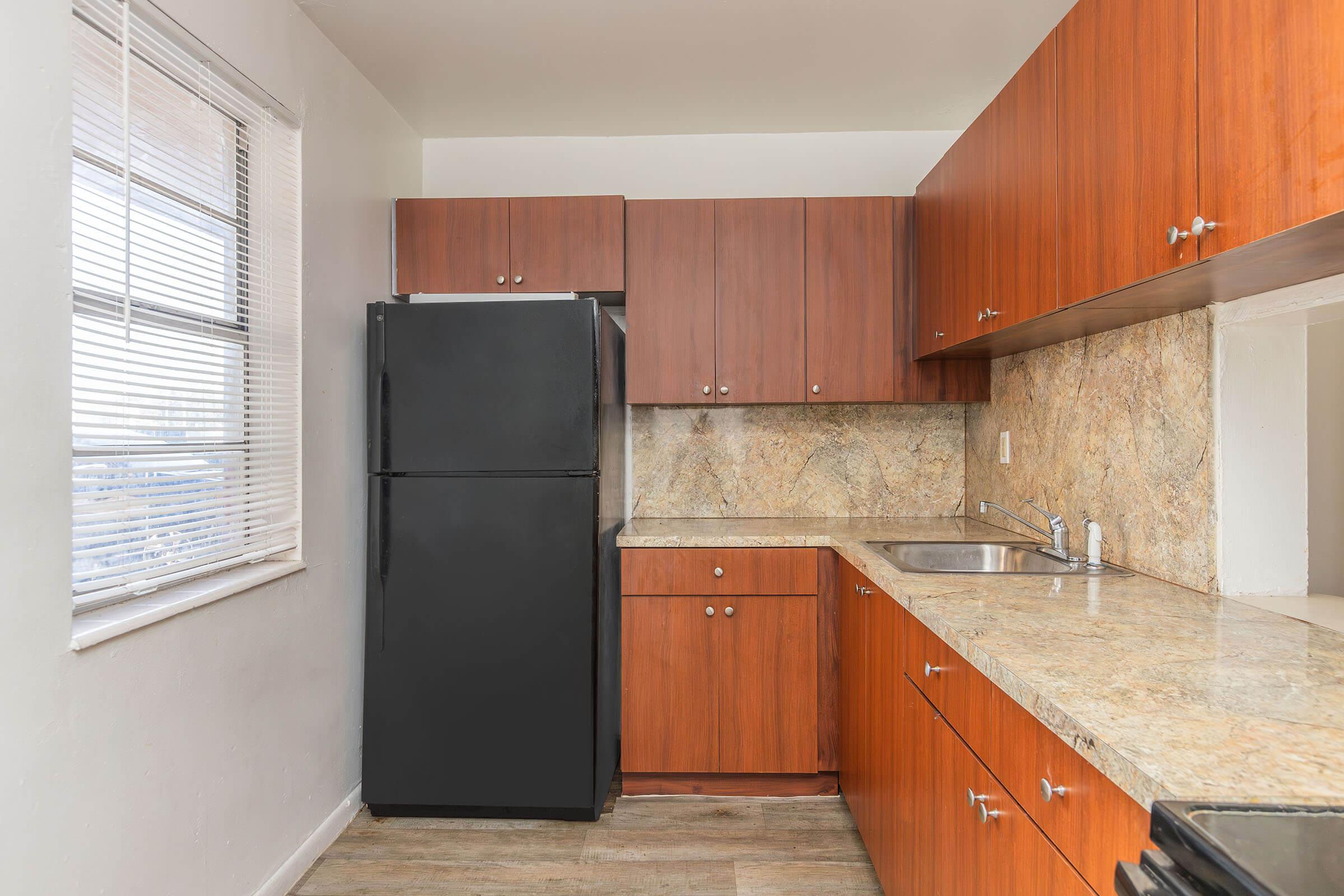 a kitchen with stainless steel appliances and wooden cabinets