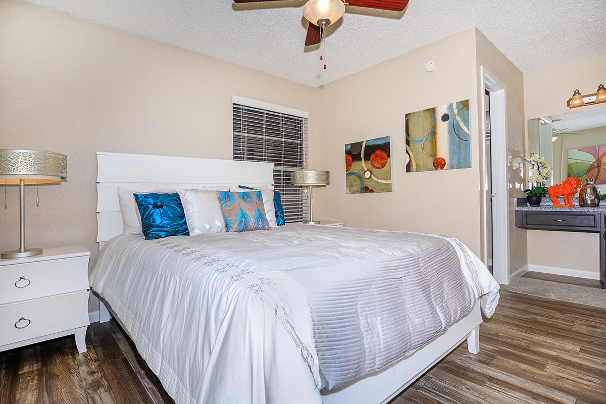 a bedroom with a bed and desk in a room