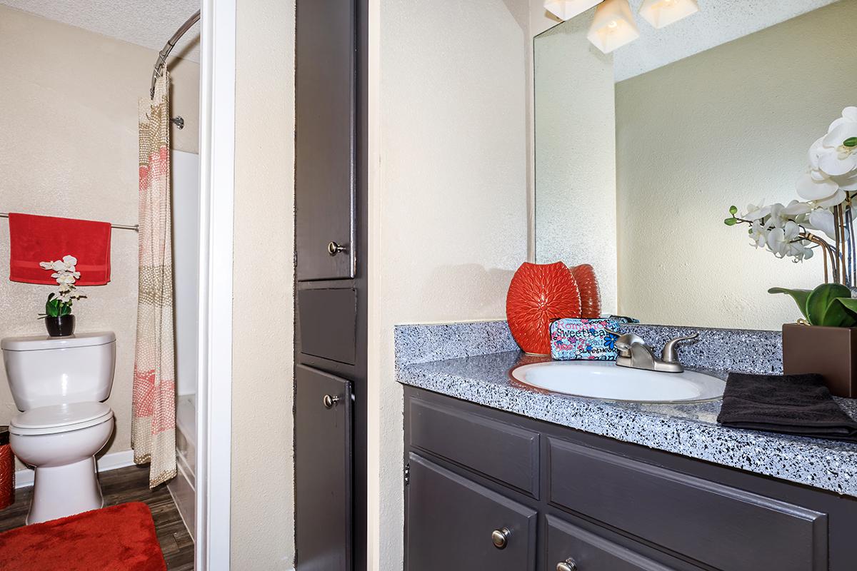 a kitchen with a sink and a mirror