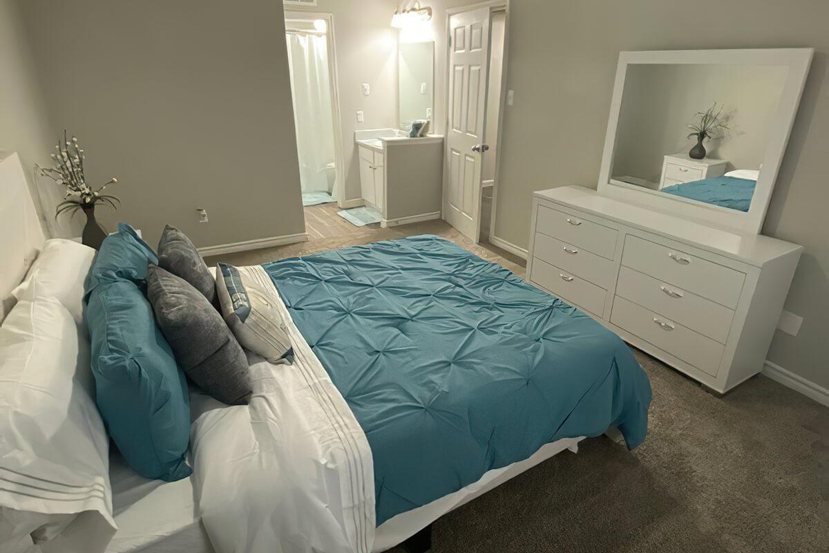 a bedroom with a bed in a room
