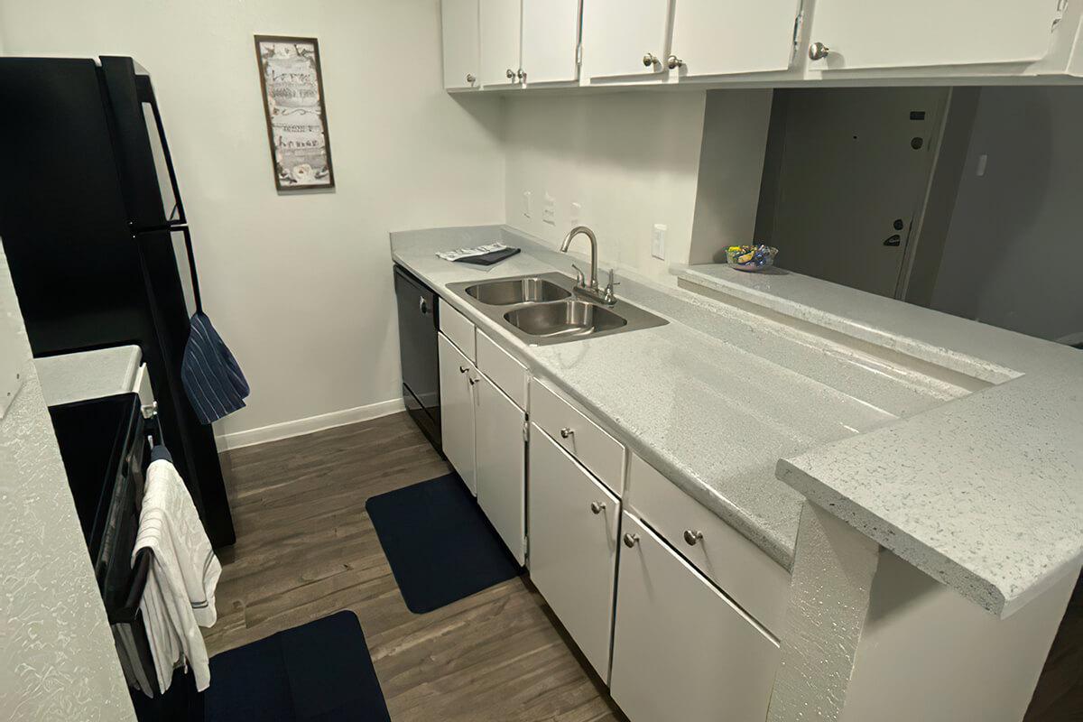 a kitchen with a sink and a mirror