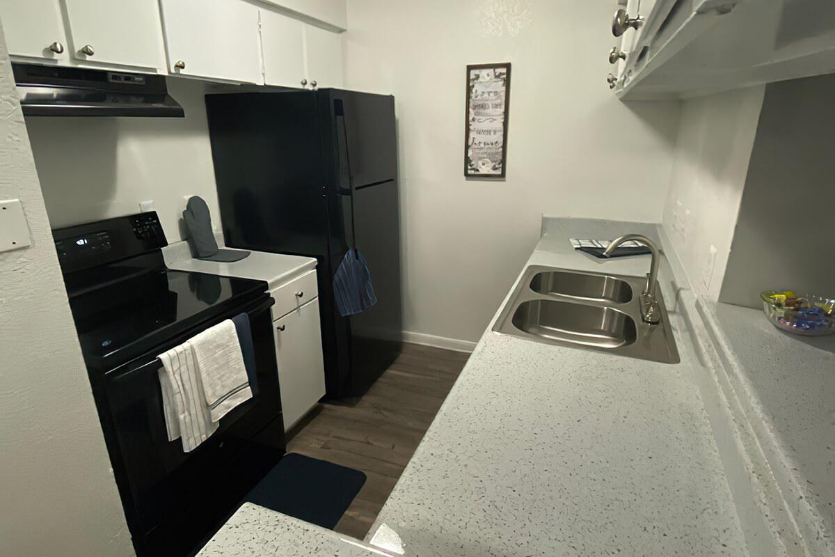 a kitchen with a sink and a mirror
