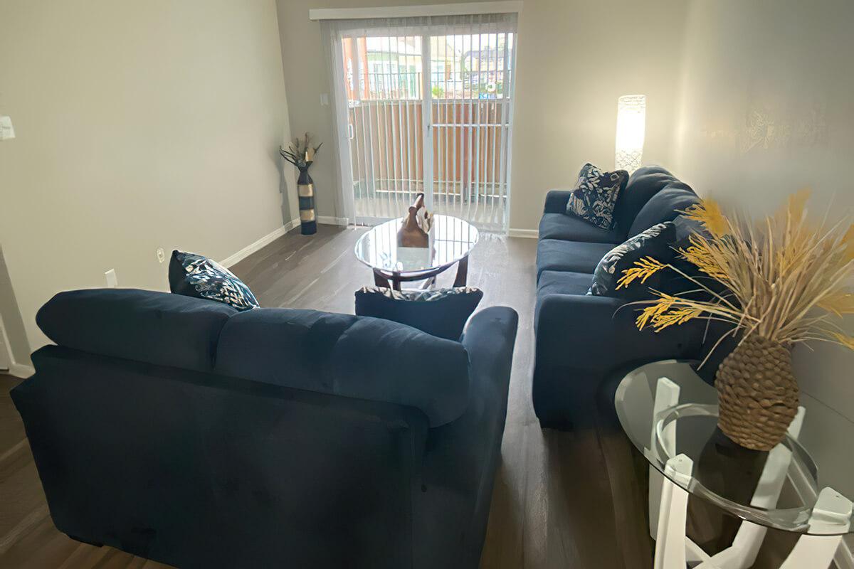 a living room filled with furniture and a window