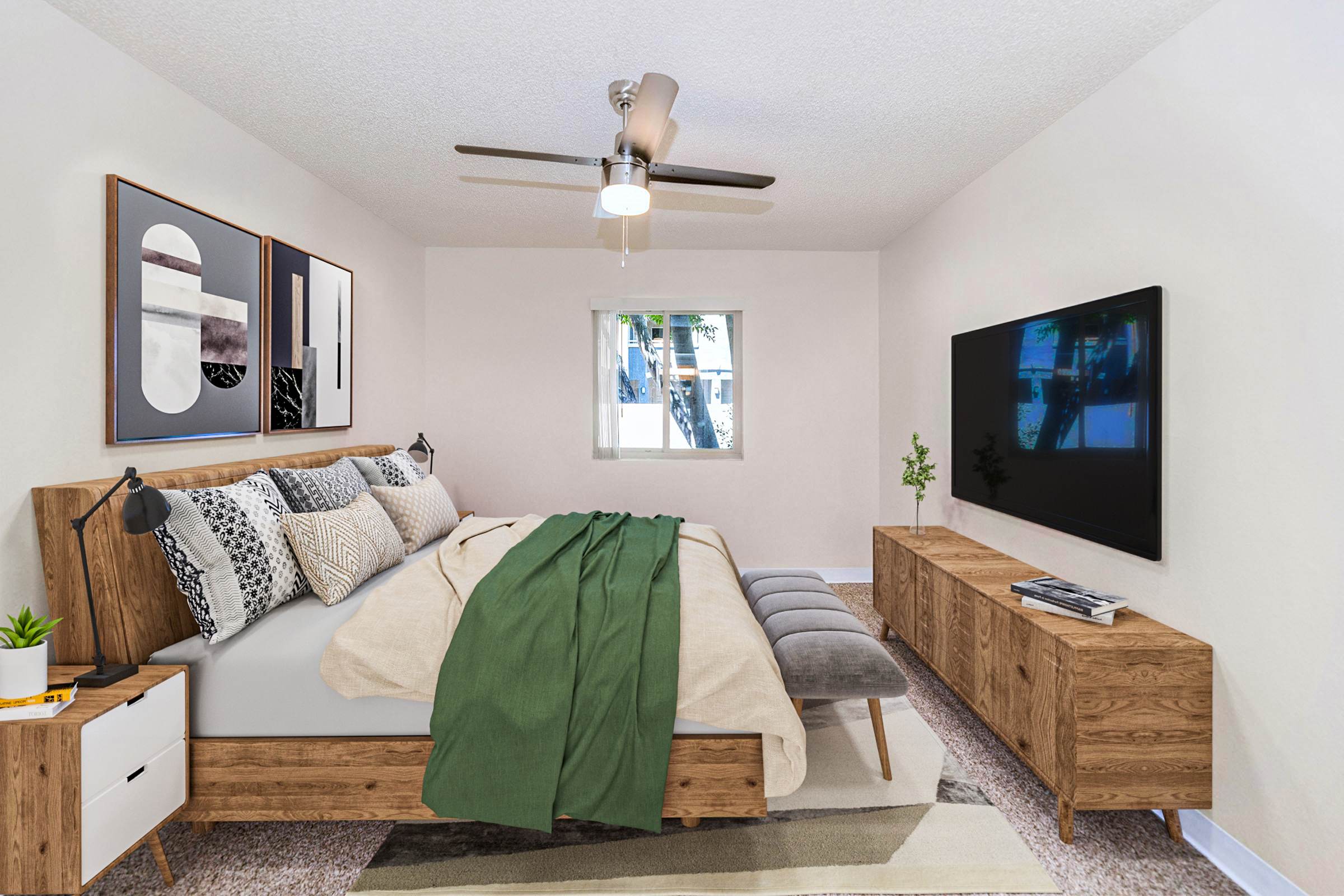 Modern bedroom featuring a wooden bed with decorative pillows and a green throw blanket, a stylish nightstand, a large TV on a wooden media console, a ceiling fan, and a window providing natural light. The walls are painted in a soft color, and a rug adds warmth to the space.