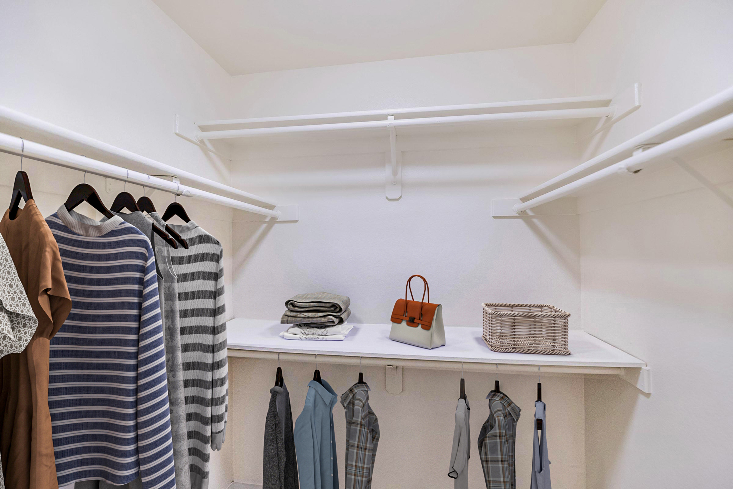 A neatly organized closet featuring several clothing items on hangers, including a striped shirt and a brown dress. A shelf displays neatly folded towels and a stylish handbag next to a woven basket. The walls and shelves are white, creating a clean and minimalist look.