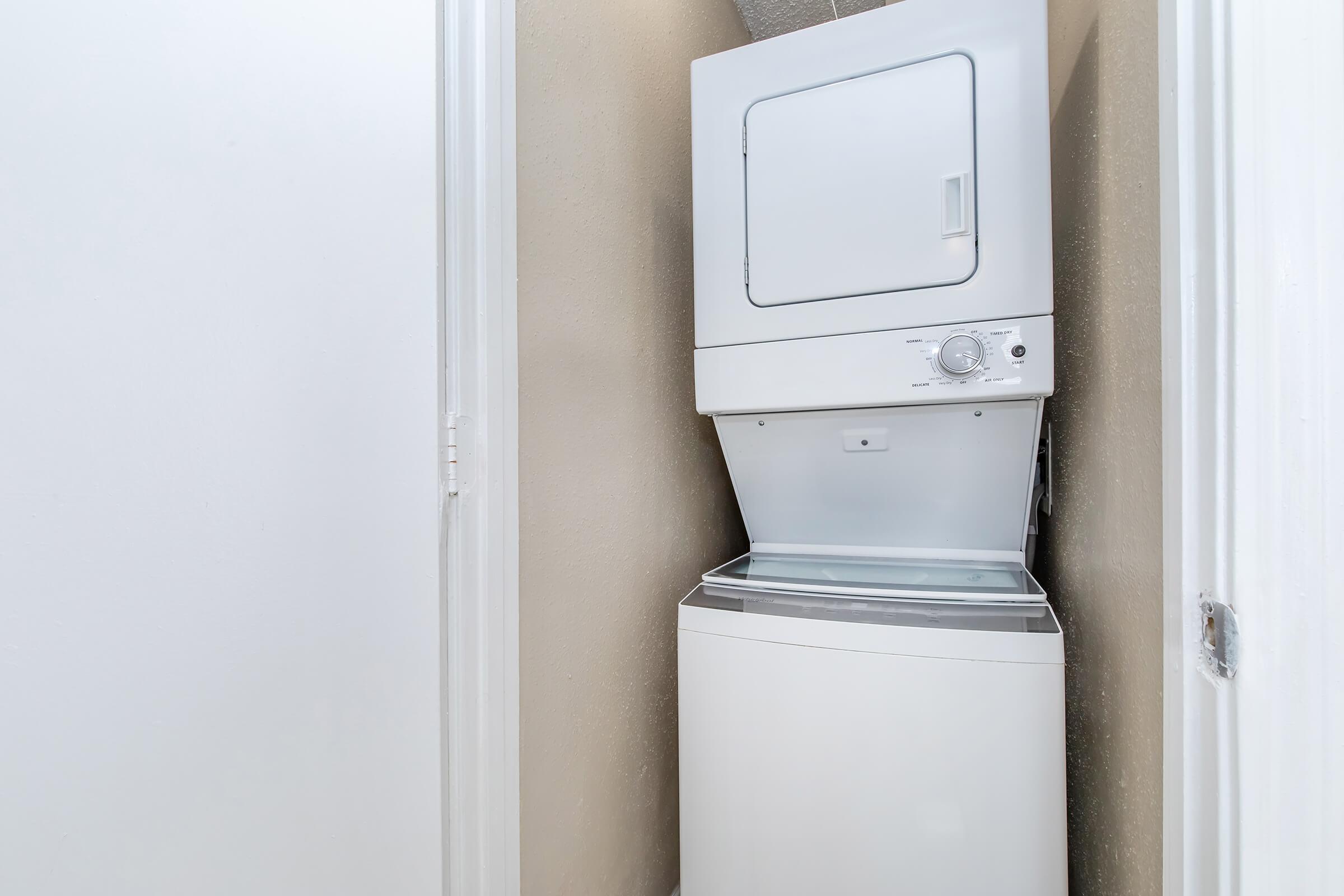 a microwave oven sitting on top of a refrigerator