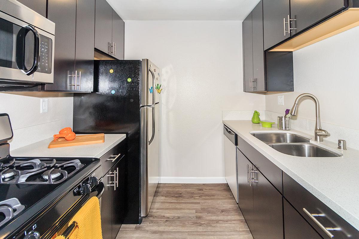 a kitchen with a stove a sink and a microwave